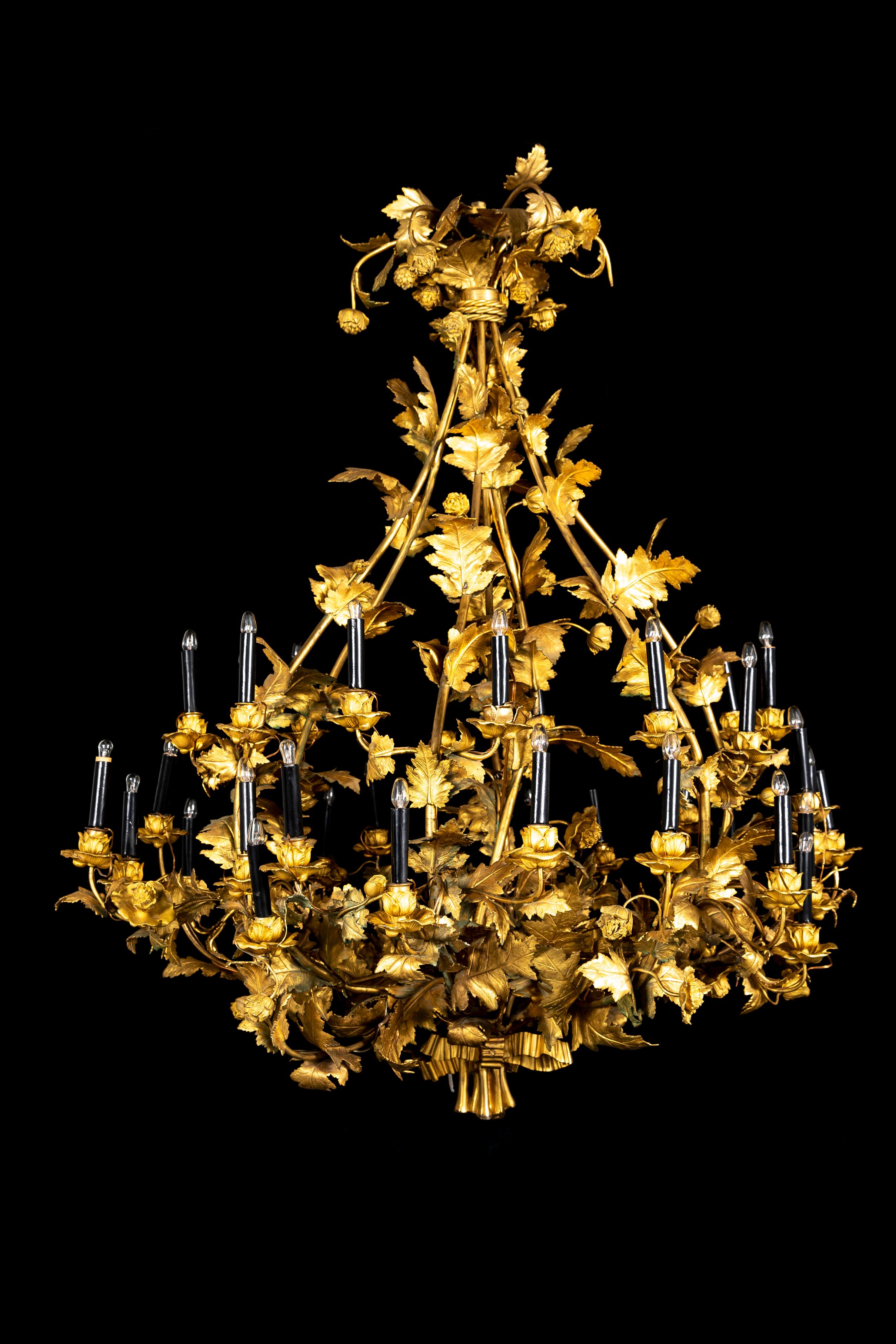 Lampadario francese a più bracci in ormolu del XIX secolo con foglie e fiori. Il corpo bulboso è composto da barre allungate di ormolu con viti, foglie e fiori di ormolu che si diramano da esse.  La moltitudine di bracci in ormolu è elettrificata