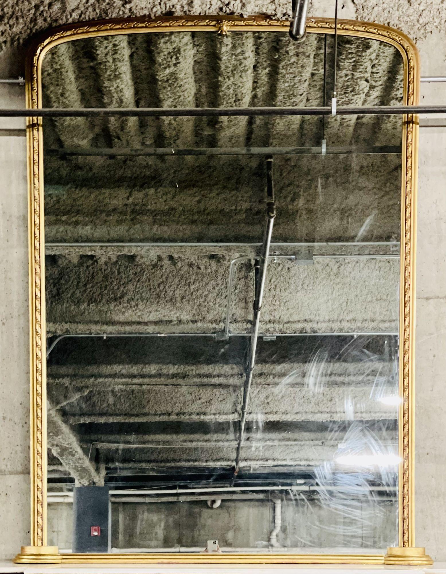 Ein französischer Mantelspiegel aus dem 19. Jahrhundert. 
 
Dieser monumentale Wand- oder Kaminsims-Spiegel ist einfach umwerfend. Die durchsichtige Platte in der Mitte wird von einem Rahmen aus vergoldetem Holz mit Seil- und Perlenmuster