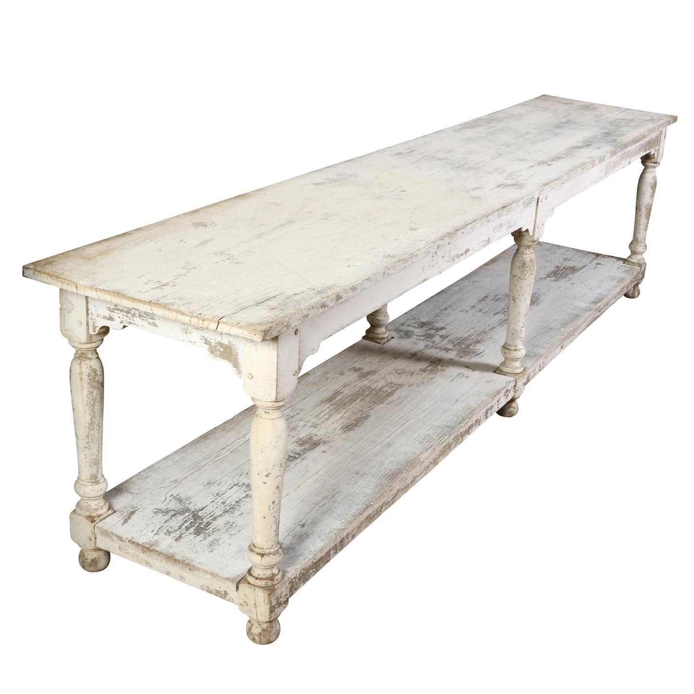 A unique and unusual long painted French drapers table with three tiers.  Originally used for cutting and folding large pieces of fabric, the table can now be used in a multitude of ways–as a console, bar, sideboard or display in a shop or studio. 