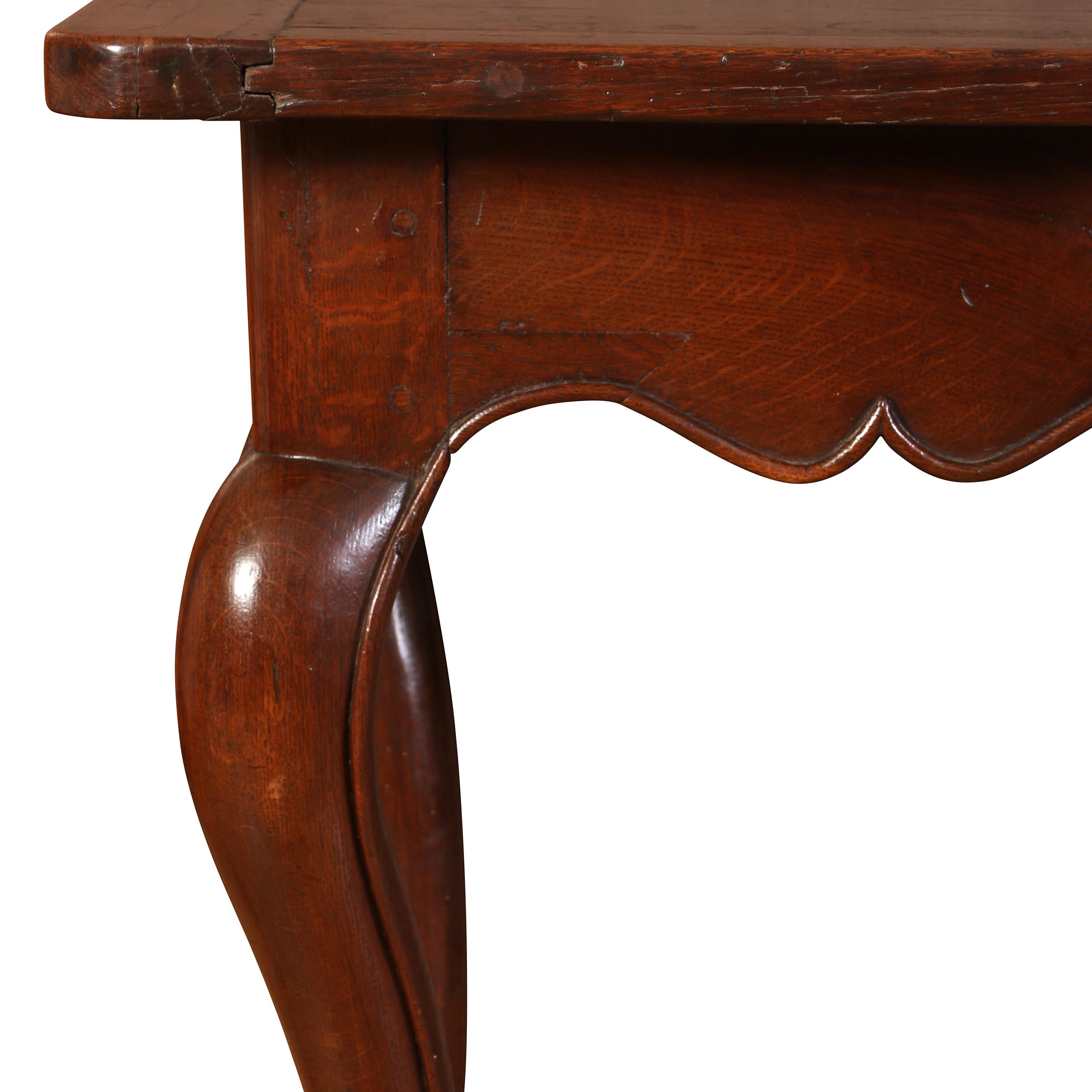 A charming 19th century oak hall or console table with, this gem has a solid oak top with two banded ends.  In the Louis XV style, the table is raised on cabriole legs and has a wonderful scalloped apron.  Having stood the test of time, the table
