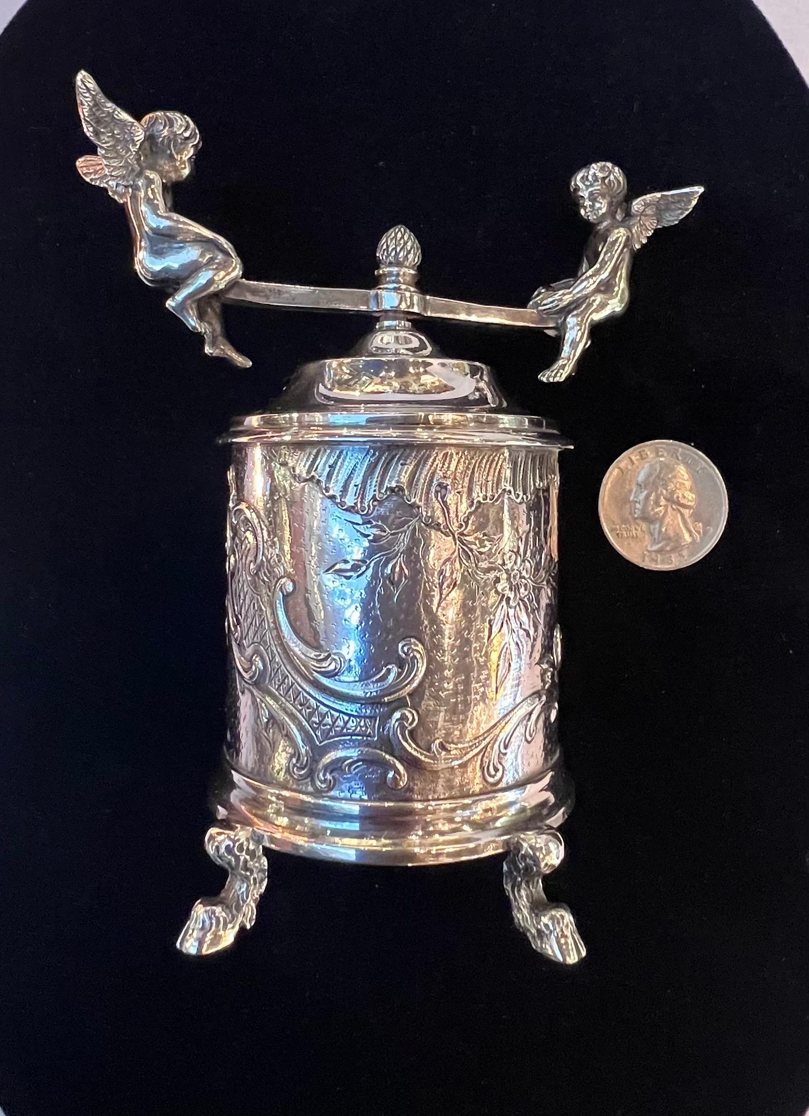 A French sterling silver Pepper Mill by Jean Granvigne, late 19th century. The mill depicting two winged putti and a repousse body resting of hoofed feet. The hallmarks at the bottom on lower side.