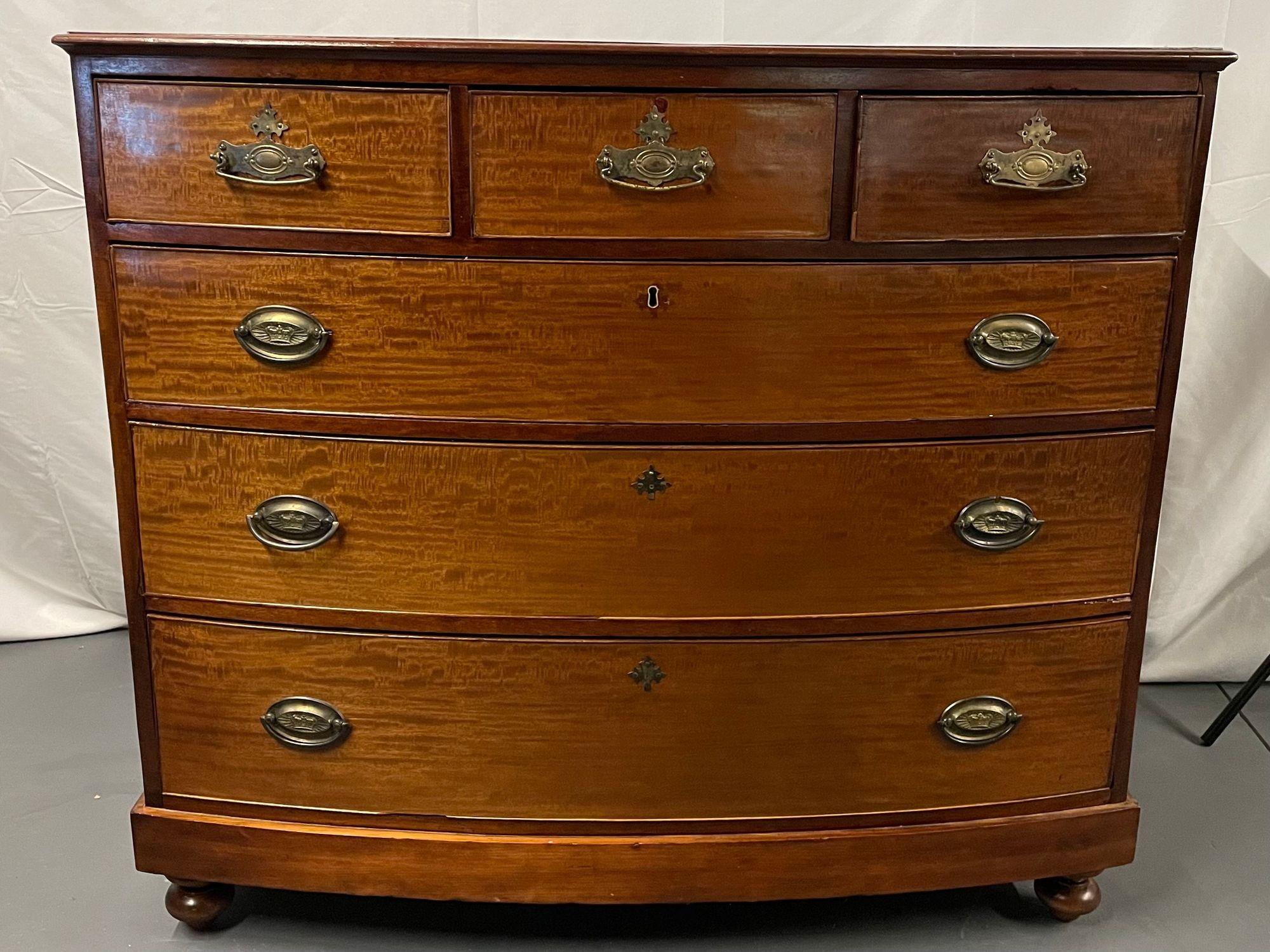 A 19th Century Georgian Bow Front Chest, Mahogany
 
A Georgian style bowfront chest having three over three graduating drawers. This rare find retains its original turned feet, brass hardware and lustrously aged mahogany.


Measures: W 45 23