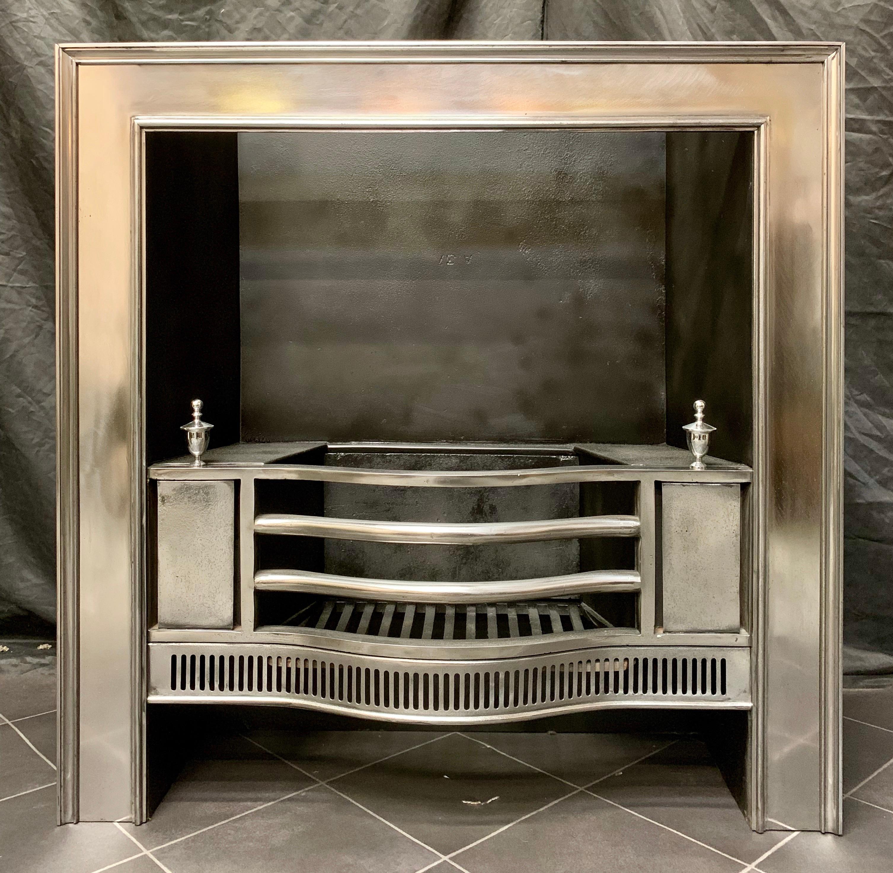 A fine antique Georgian polished steel fireplace register grate insert with a frame of moulding to the border, a three barred grate surmounted by a pair of polished finials above a cut and beaded apron.
The coloring on the polished steel photos is
