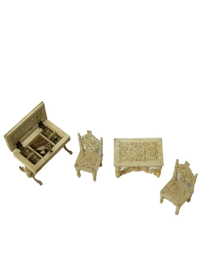 A 19th century German Doll house miniature furniture 

A sewing table, a table and 2 chairs. 
The sewing table has a flap and the table has 5 compartments with a small scissor, a thimble and spools of thread inside

This miniature furniture is