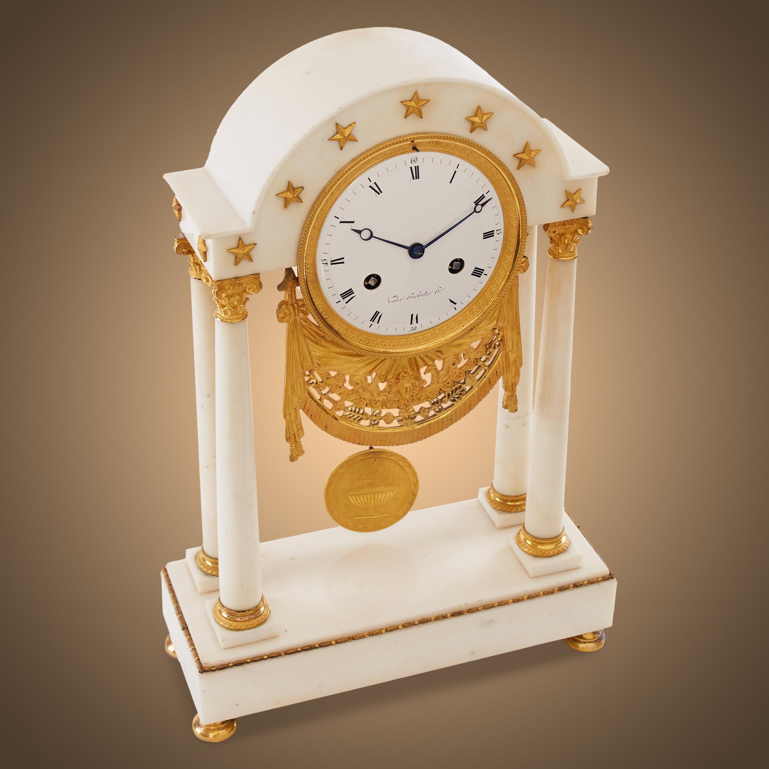 A 19th century gilt bronze and white marble portico clock.