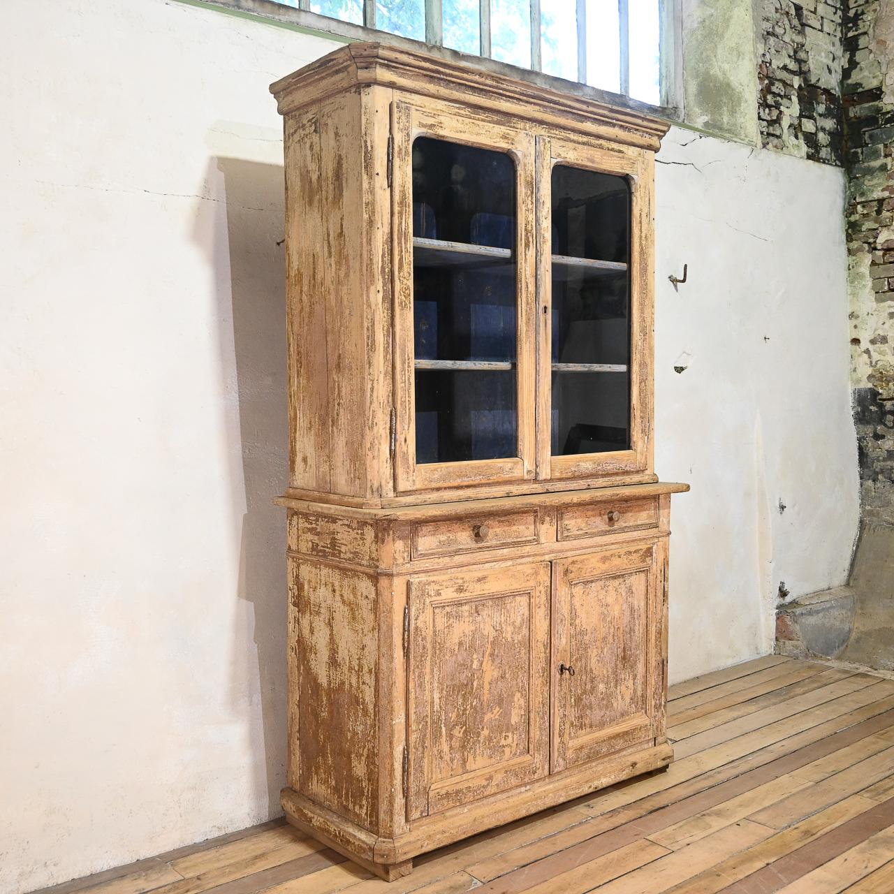 Introducing a remarkable mid-19th century French glazed cabinet, showcasing timeless elegance and vintage charm. This exquisite piece features a pair of glazed doors that enclose a shelved interior, providing ample space for displaying treasured
