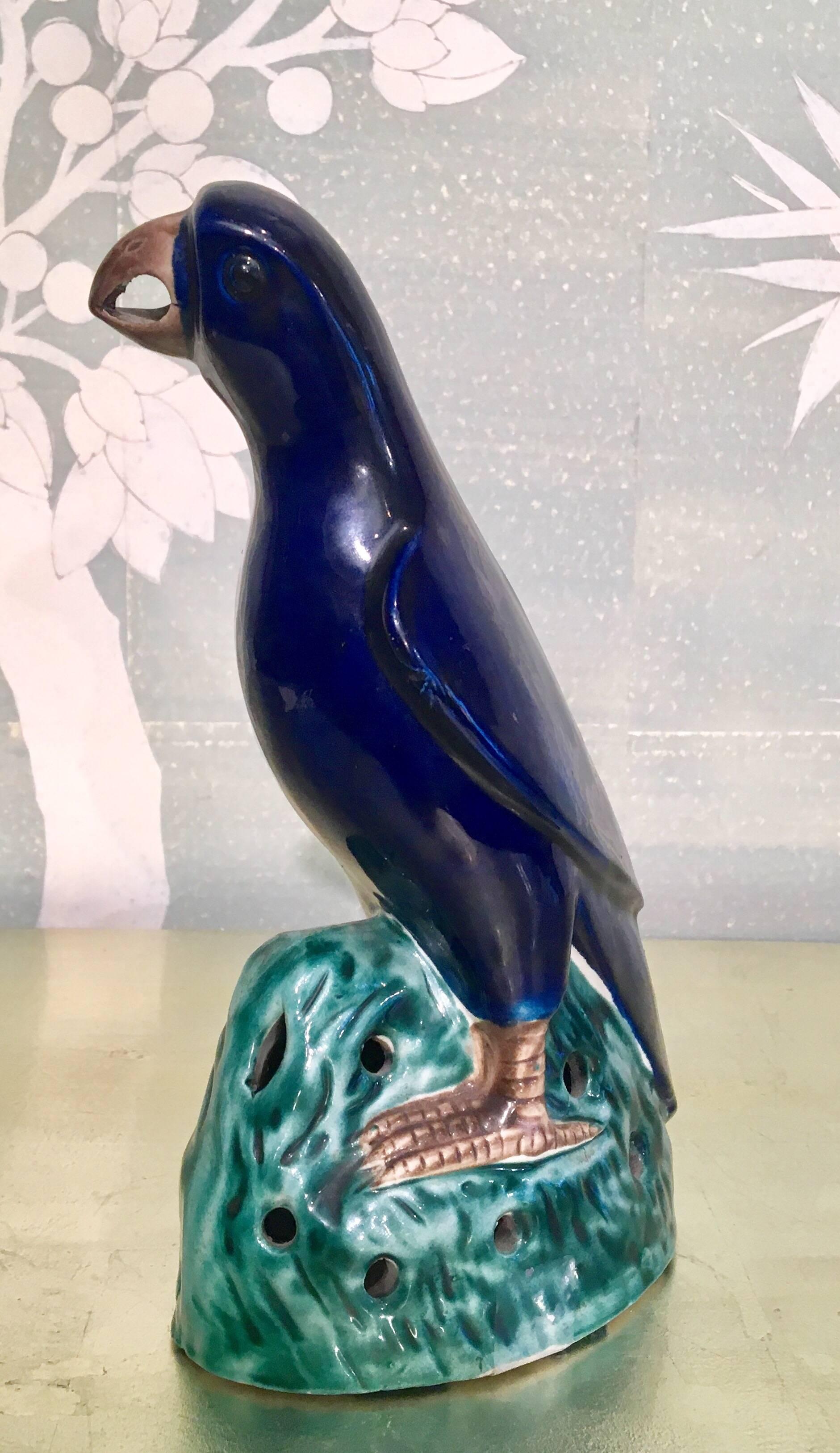 A 19th century Chinese blue glazed parrot with green base.