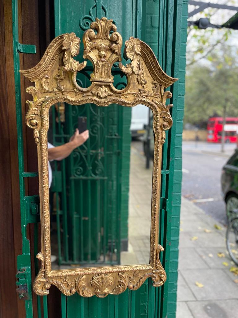 A 19th Century Gold Gilt Mirror with Prince of Wales Feather and Floral Carvings. This mirror belonged to the late Mr Harold Sebag-Montefiore and came out of his residence just off Kensington Church Street - Vicarage Gate.

Harold Henry
