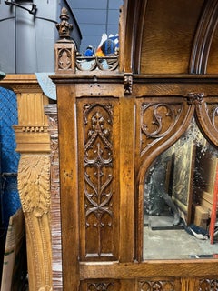 A 19th Century Gothic Carved Wood Hall Tree with Seat and Mirror.