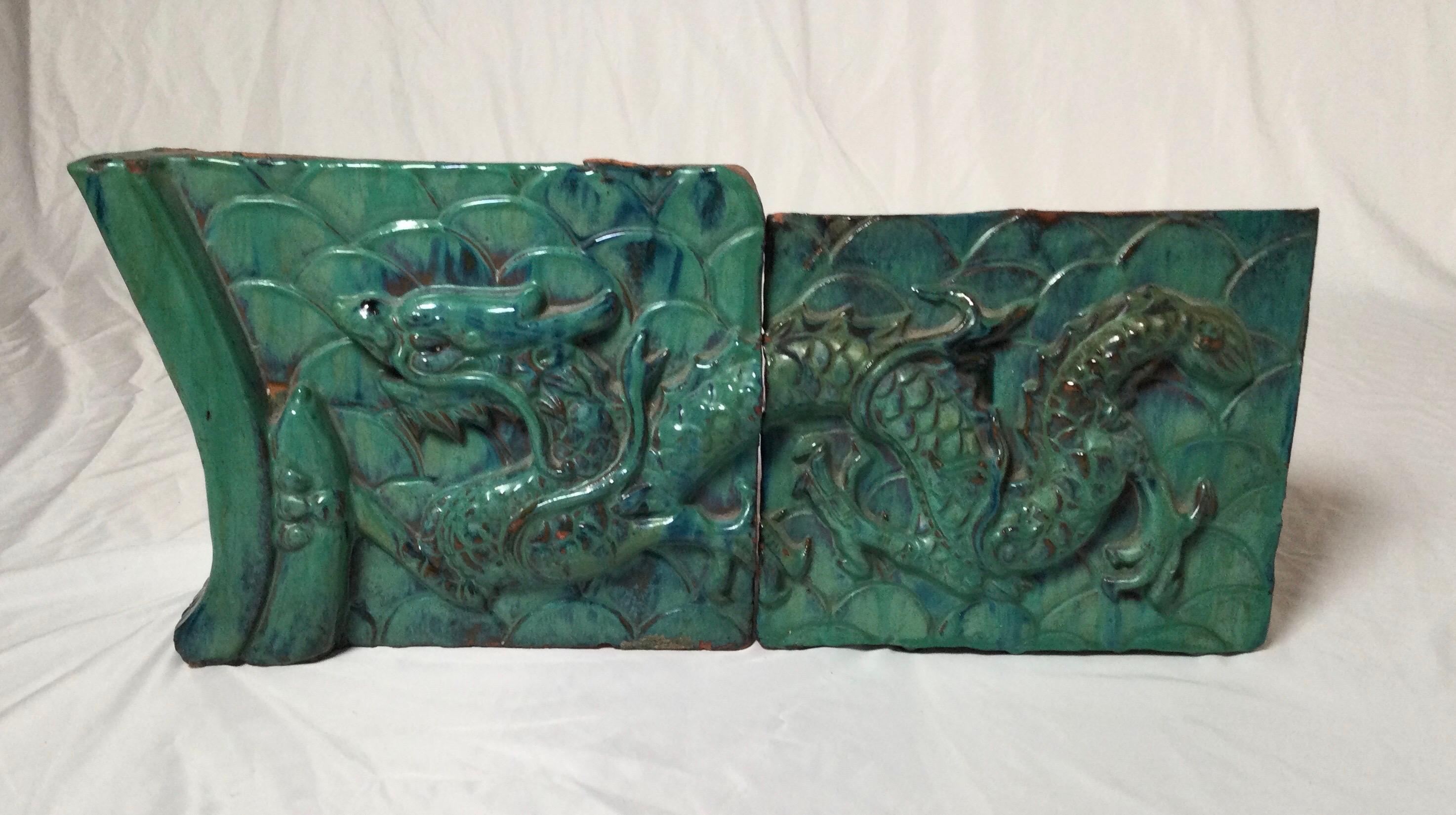 A high relief 2 part earthenware glazed dragon motif architectural element. The exceptional detail with a beautiful blue-green high glaze. Measures: 22 wide, 9.5 high, 2.5 deep.