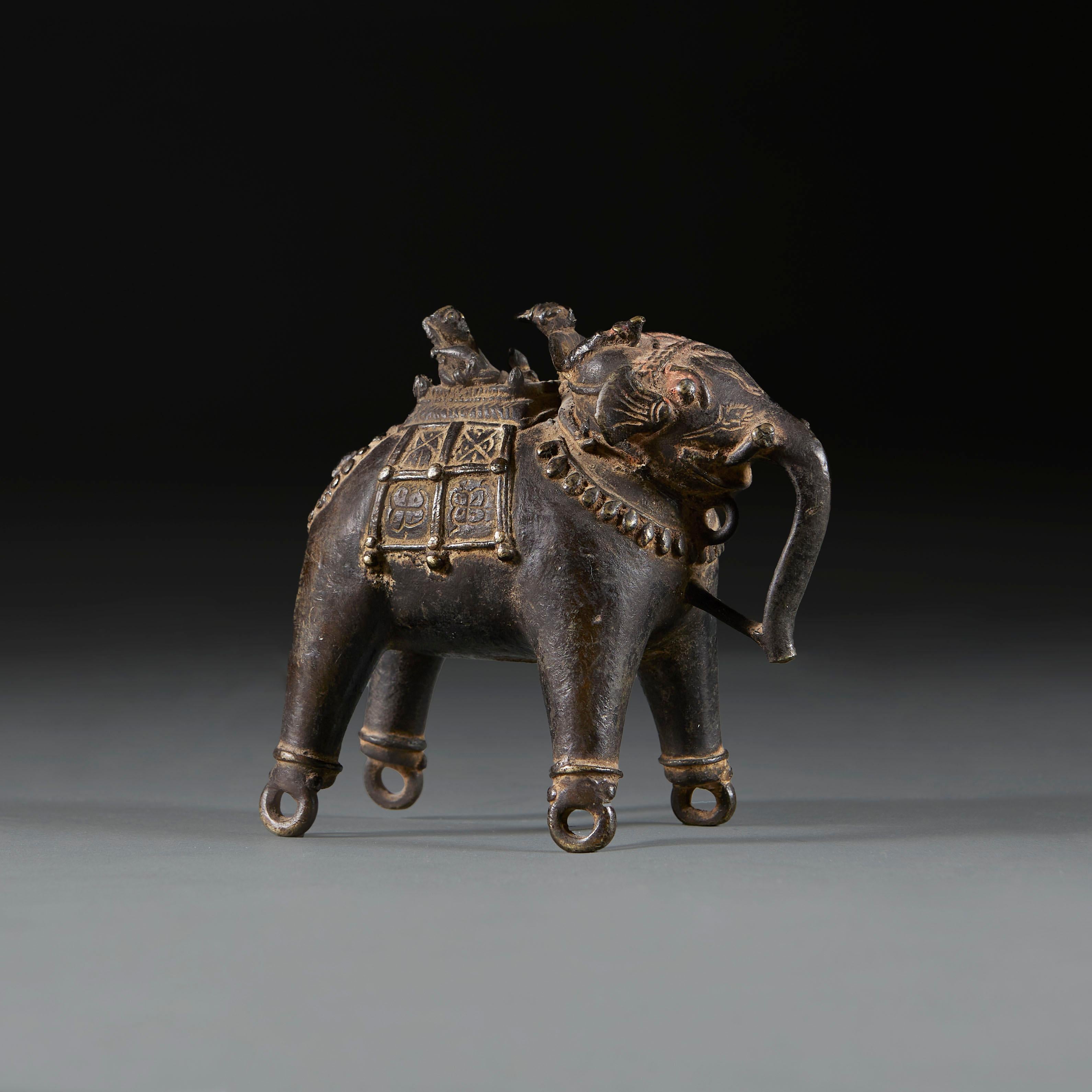 India, circa 1880

A nineteenth century solid bronze Indian elephant mounted by a Mahout carrying one passenger in a traditional howdah carriage, incised with decoration throughout and originally used as a toy. 

Height 15.00cm
Width 8.00cm
Depth