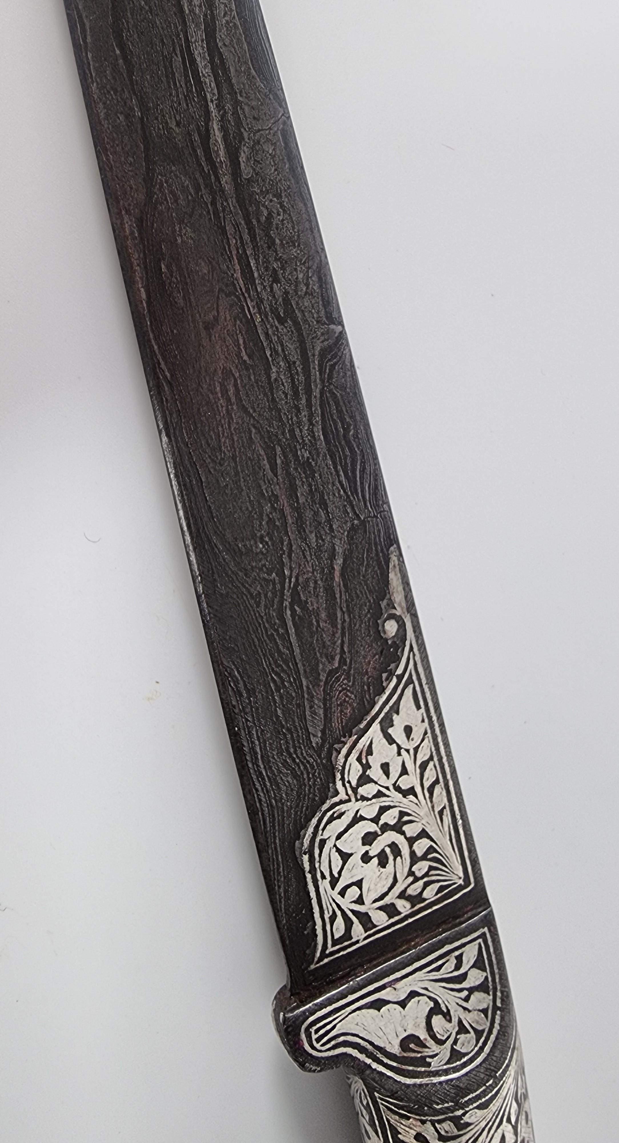 19th Century A 19th century Indian silver inlaid dagger with a Damascus steel blade, C 1870 For Sale