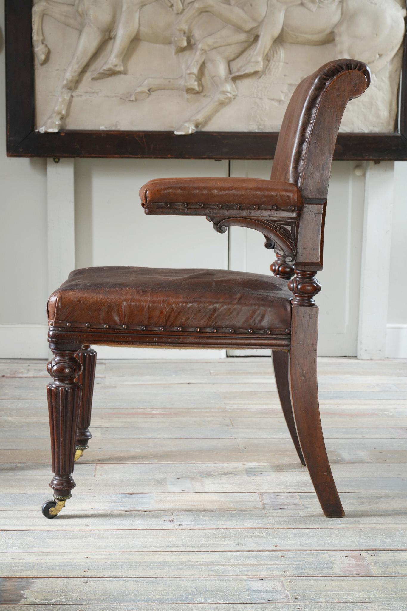 Mahogany with its original patinated leather upholstery. 