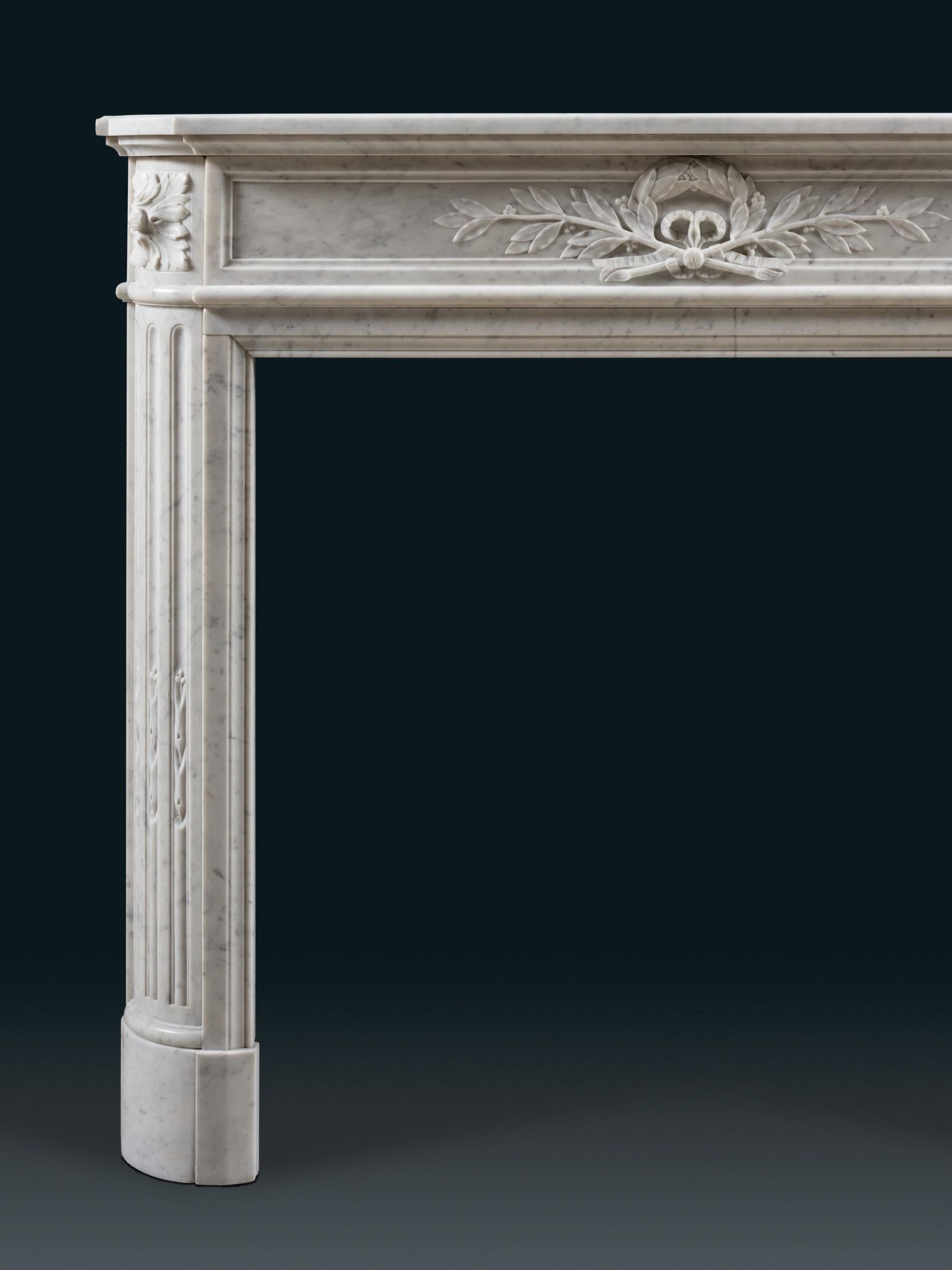 An Imperial 19th century chimneypiece of good proportions carved in well preserved Carrara marble. The statuesque piece has canted jambs carved with flutes filled with Campanula, otherwise known as Bell Flowers. The flower symbolised a feeling or