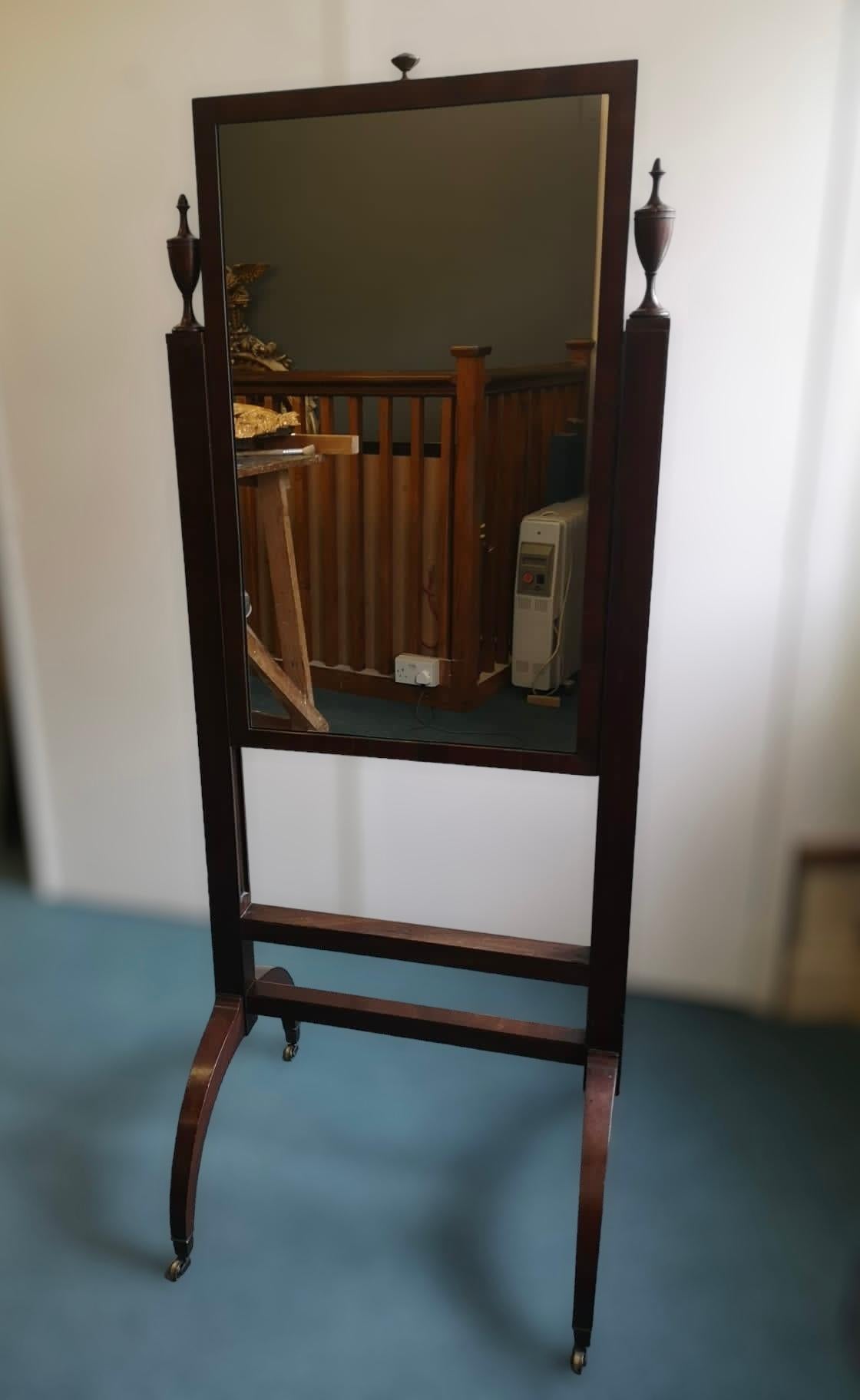 A 19th century Mahogany inlaid adjustable rectangular Cheval Mirror with turned finials and arched outswept legs on Brass castors.

Height 143cm Extended 155cm