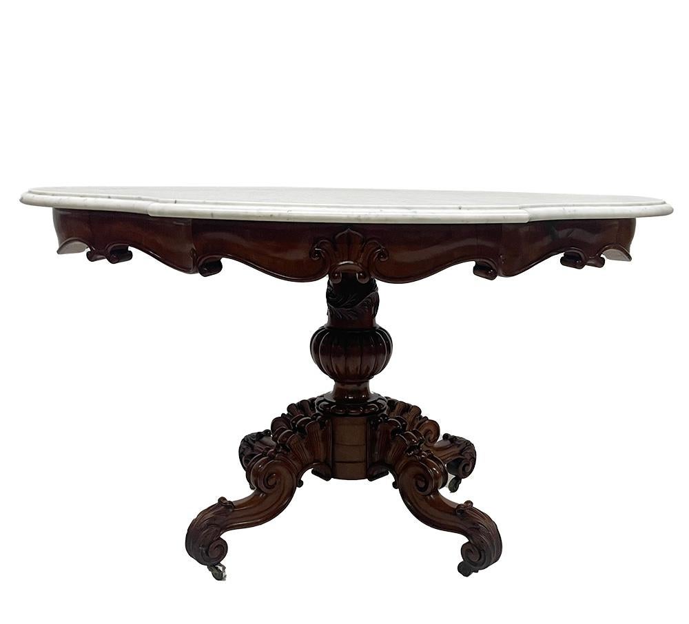A 19th Century mahogany table with a cartouche-shaped marble top, ca 1840

A beautiful Dutch mahogany table with a four-legged cabriole shaped with Acanthus leaf table leg base, raised on castors with a white and grey cartouche-shaped marble top