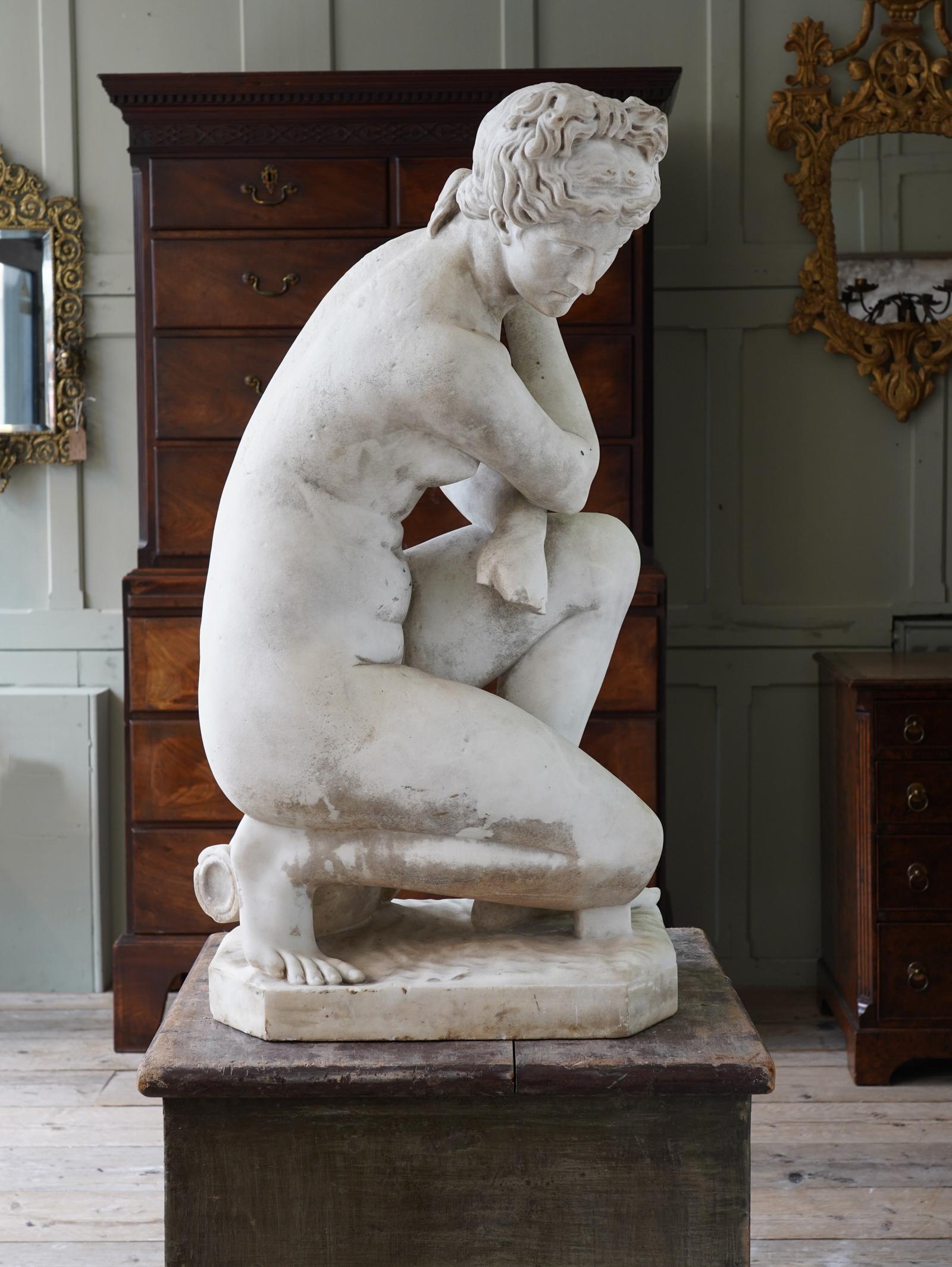 A statuary marble figure of the crouching Venus.
-------------
This sculpture depicts Venus, classical goddess of love and beauty, surprised while bathing. She crosses her arms in an attempt to conceal her nudity and turns her head away in