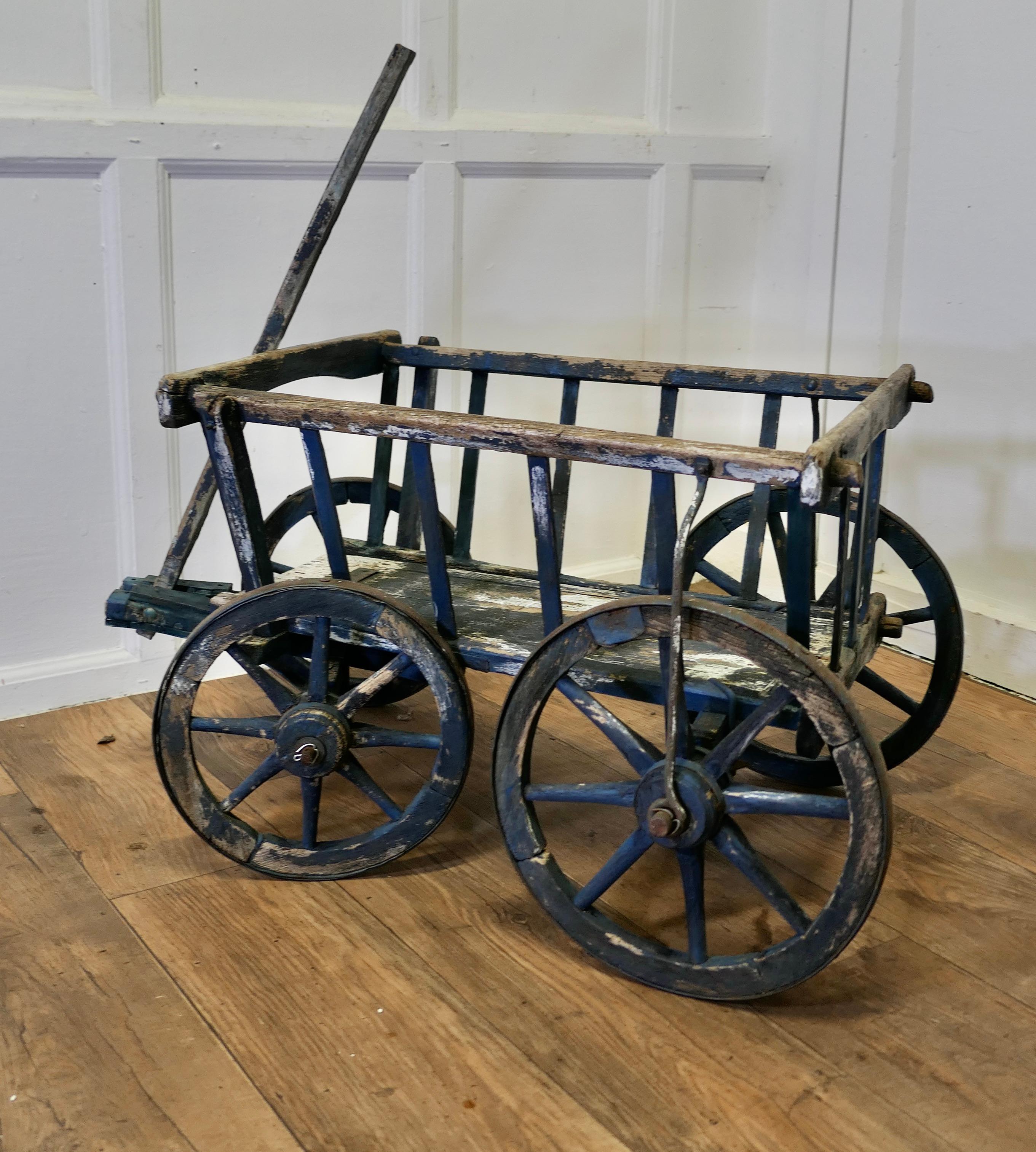 A 19th Century Market Garden Hand Cart or “Dog Cart”

The cart or Barrow is made in pine it is in good sound condition, it has been stored indoors and so not had to suffer harsh weather
The cart has big iron bound wheels and very easy to manoeuvre