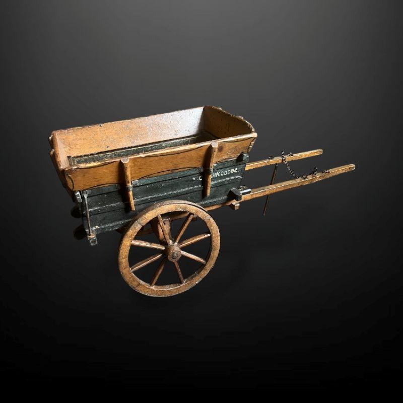A very fine scale model of a late 19th Century tipping ‘muck cart’.

A tumbrel is a two-wheeled cart or wagon typically designed to be hauled by a single horse or ox. Their original use was for agricultural work; in particular they were associated