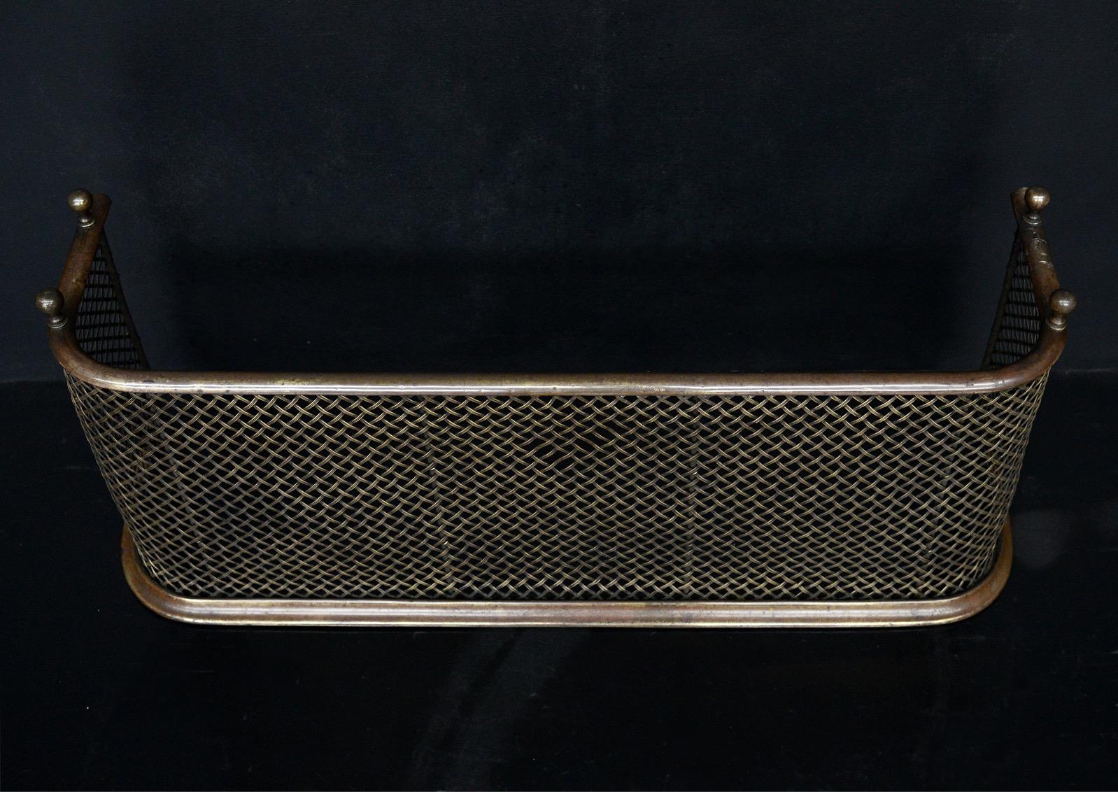 A small English brass nursery fender. The shaped front with crosshatched mesh and ball finials above. Some minor mesh work missing to front - see photos. Sold as seen. 19th century.

External Width:	825 mm      	32 ½