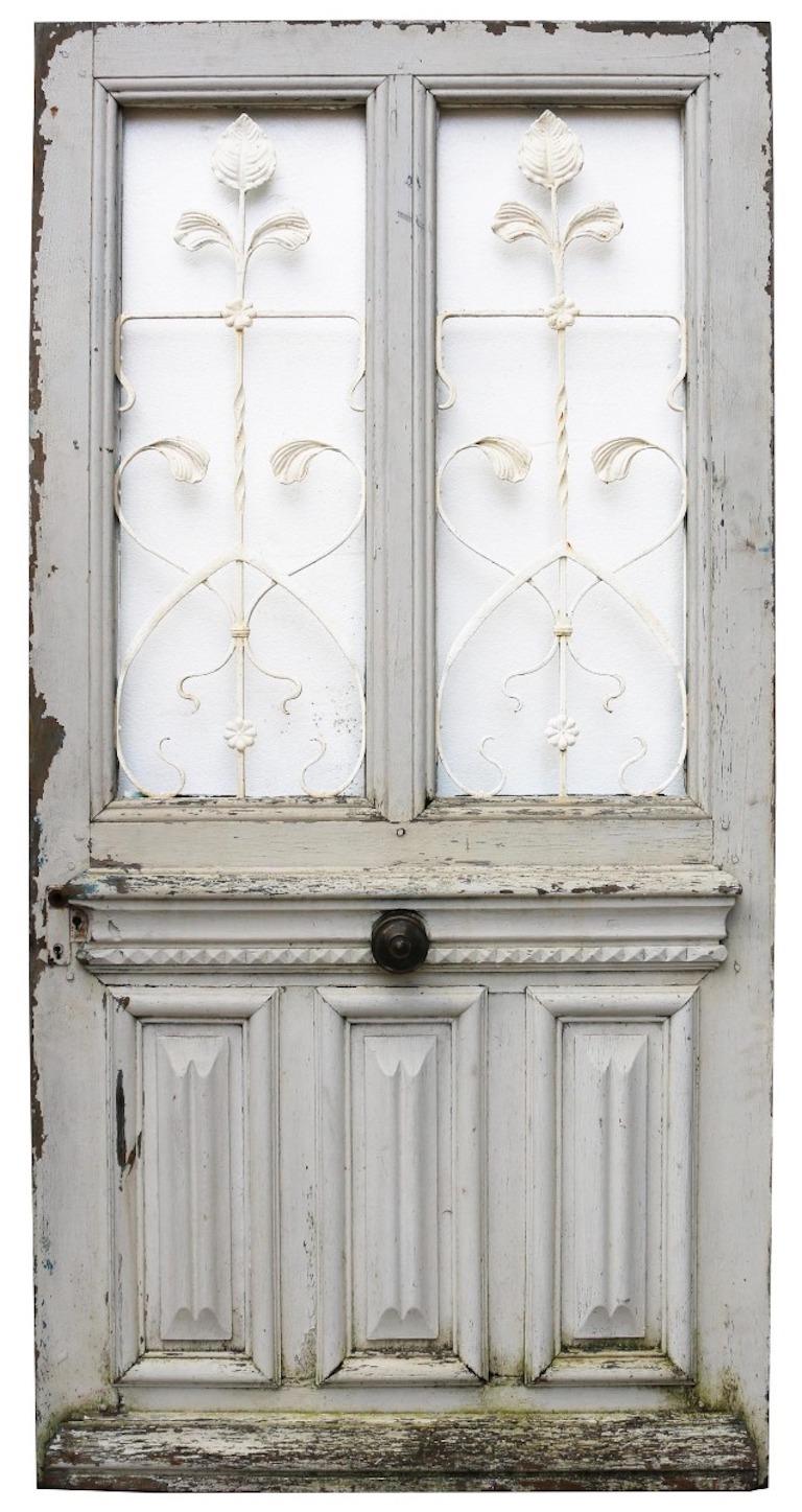 A reclaimed French external door with shabby paint finish. Constructed from oak and fitted with iron grills and opening windows.