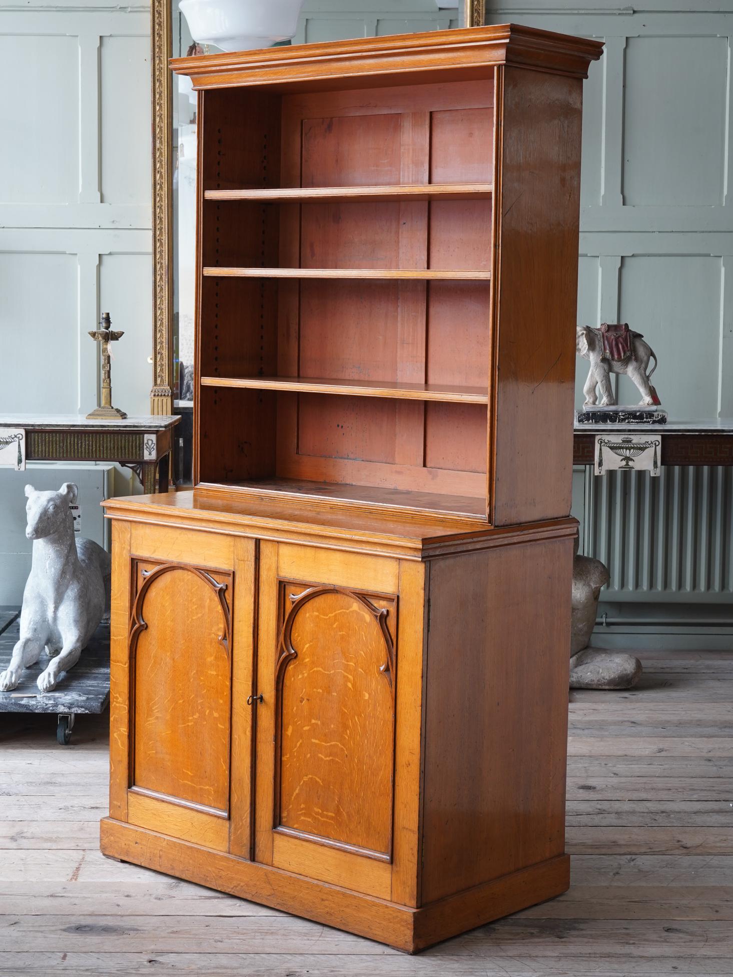 The open adjustable shelves above the two door cupboard with Gothic tracery mouldings to the door fronts with a single adjustable shelf behind.

Working lock and key.

Very good original condition.


   