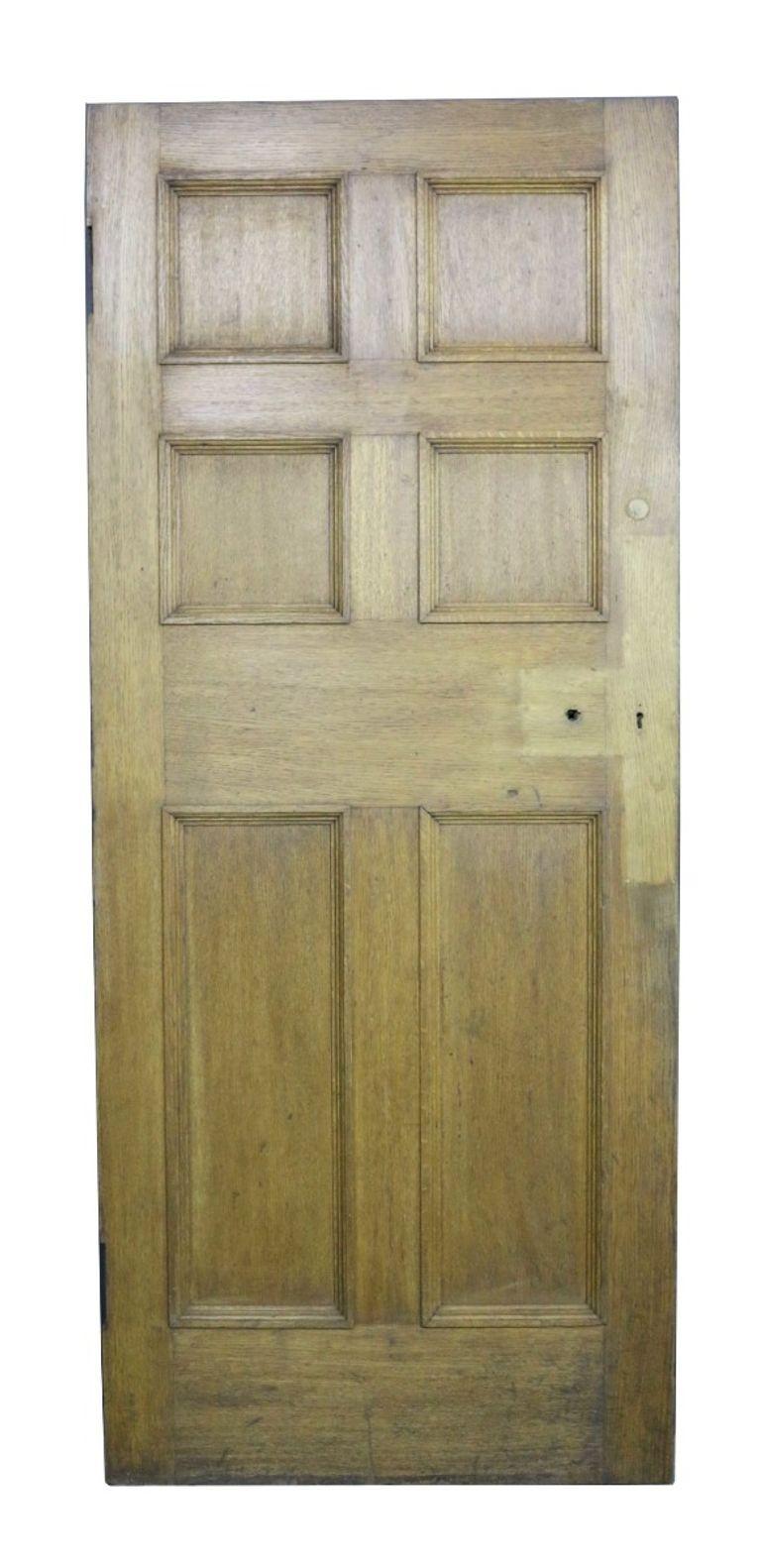 A reclaimed oak interior door of six panel design.