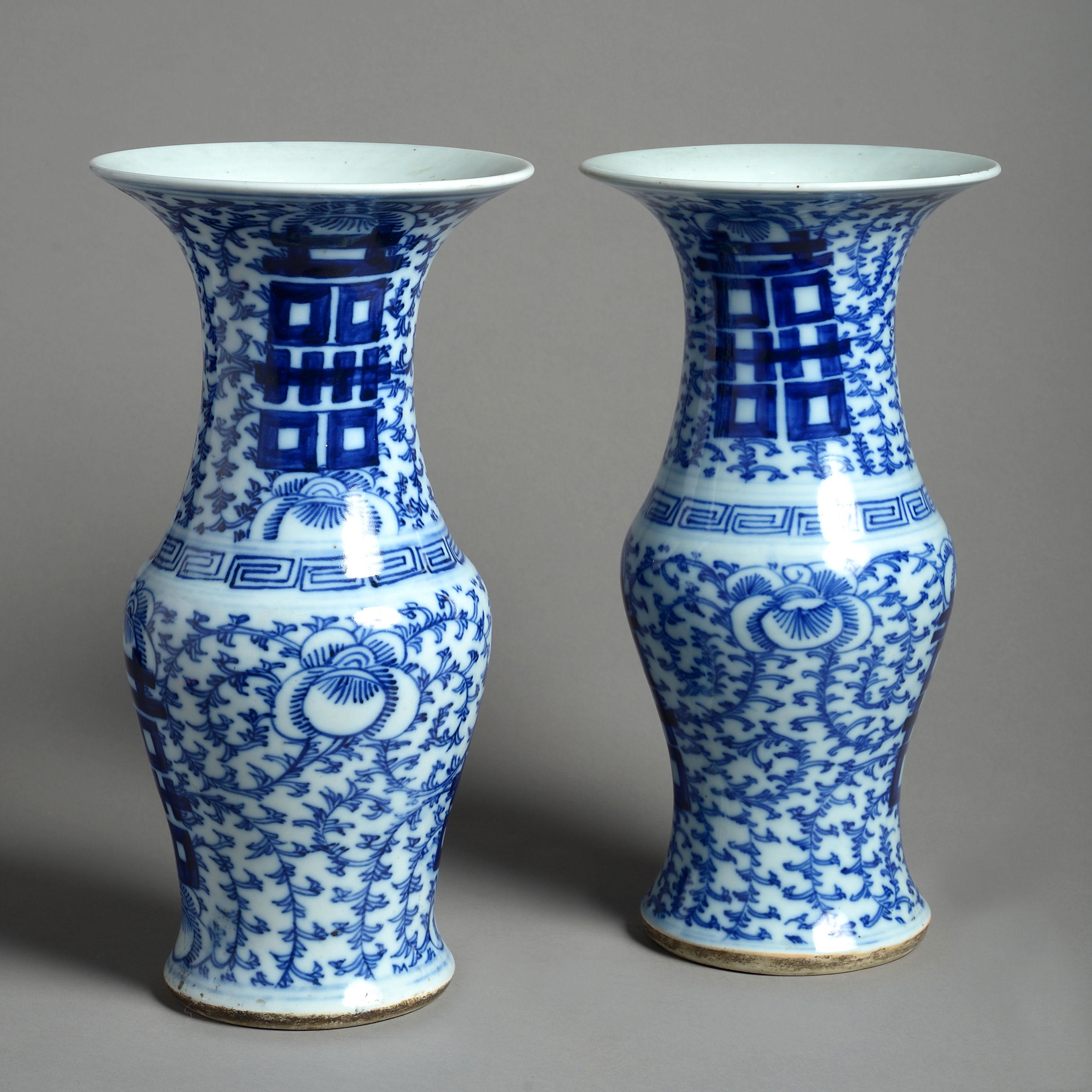 A fine pair of blue and white porcelain vases of trumpet form, the bodies decorated with stylized foliage, Greek key and family marks.
 