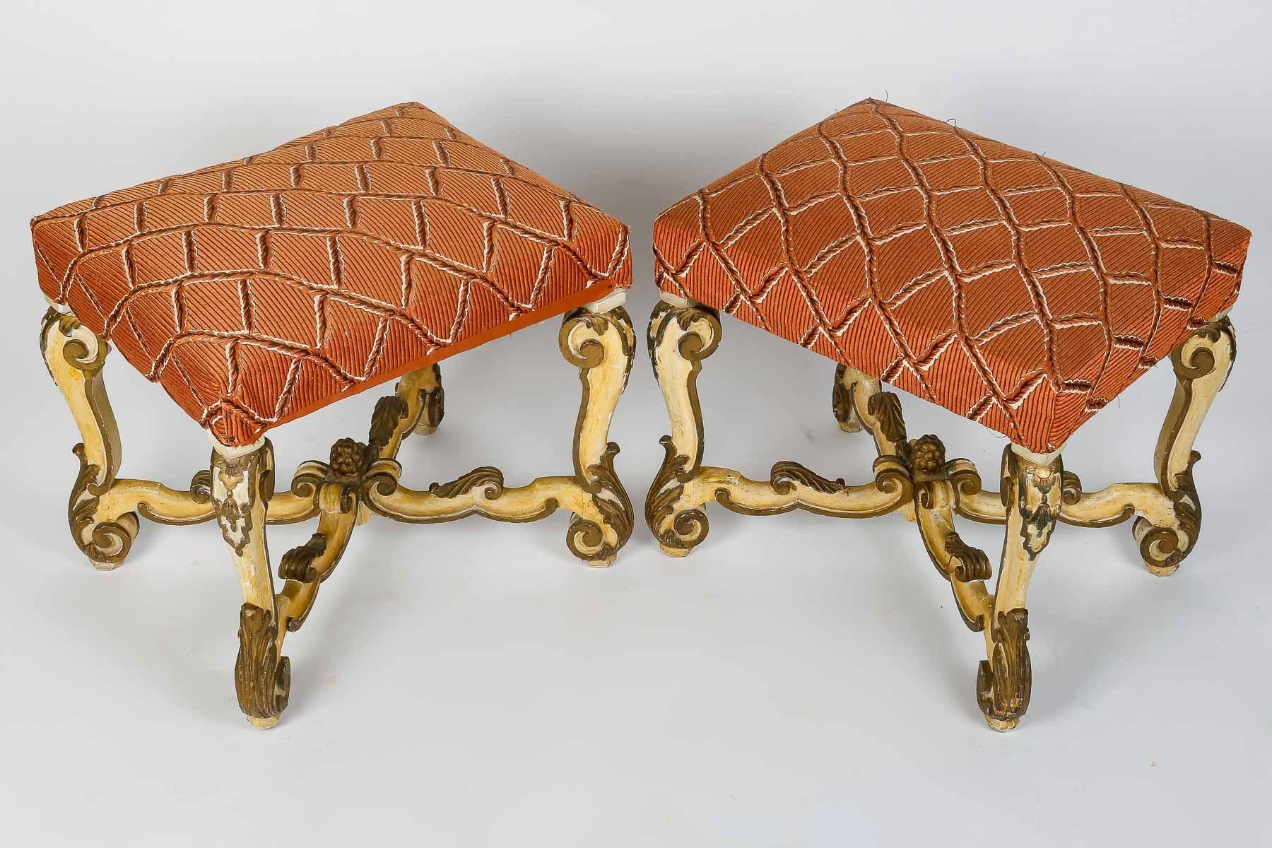 A 19th Century Pair of Italians Baroque Style Stools
A gilt and lacquered wood pair of stools
The padded seat upholstered, above double 'C' scrolls and shell carved legs joined by a scrolling 'X' from stretcher with a pinecone finial, on shell