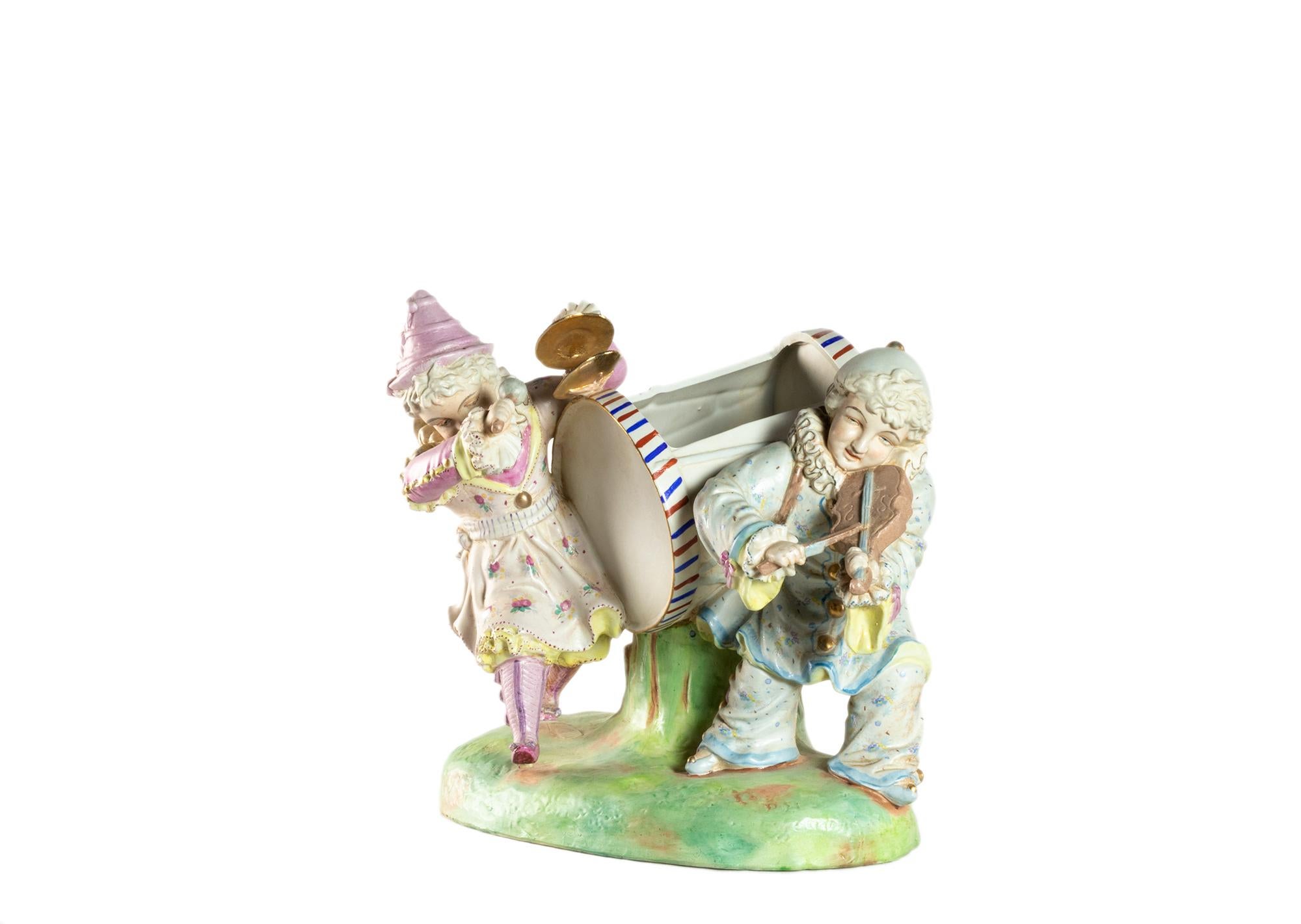 A Saxony art piece, large polychrome porcelain of a figurine of a male violinist and a women`s percussionist musicians decorated in the pierrot.
A dreamlike motif of youth playing music.
Style of the late XVII century and XIX century in the