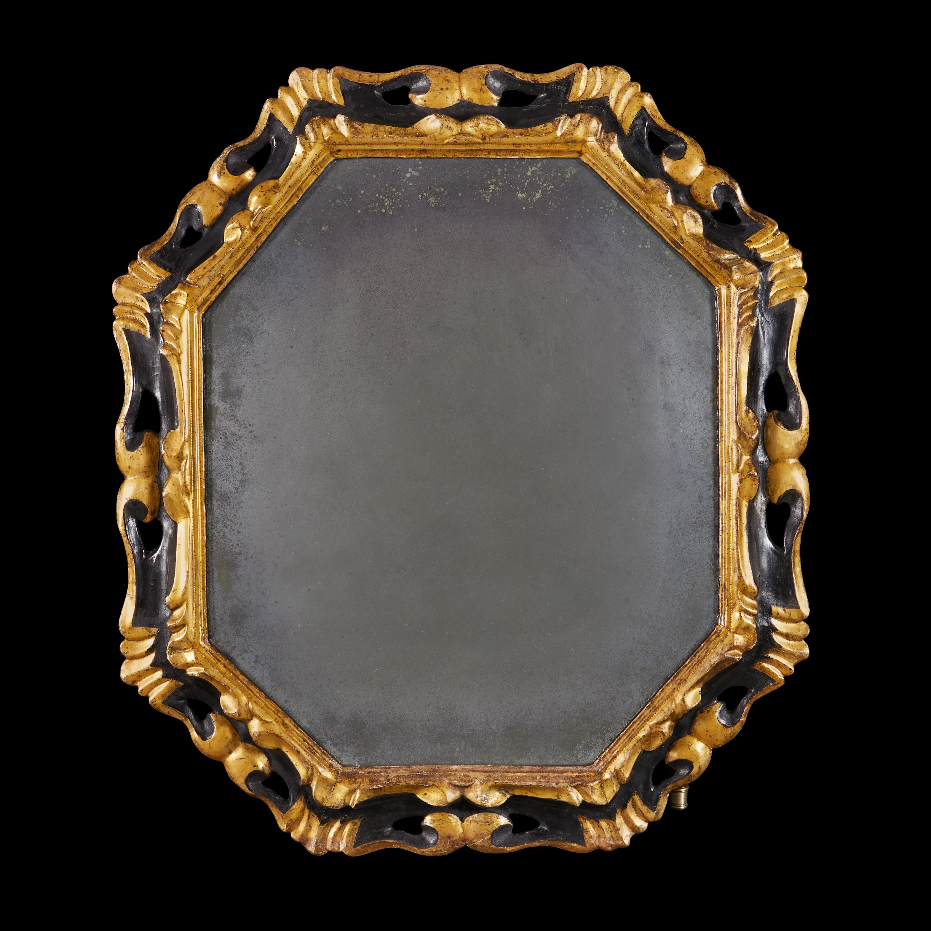Italy, circa 1850

A striking mid nineteenth century octagonal mirror, with pierced rocaille border, the surface ebonised with gilded highlights, retaining the original mercury mirror plate.

Height  93.00cm
Width    80.00cm