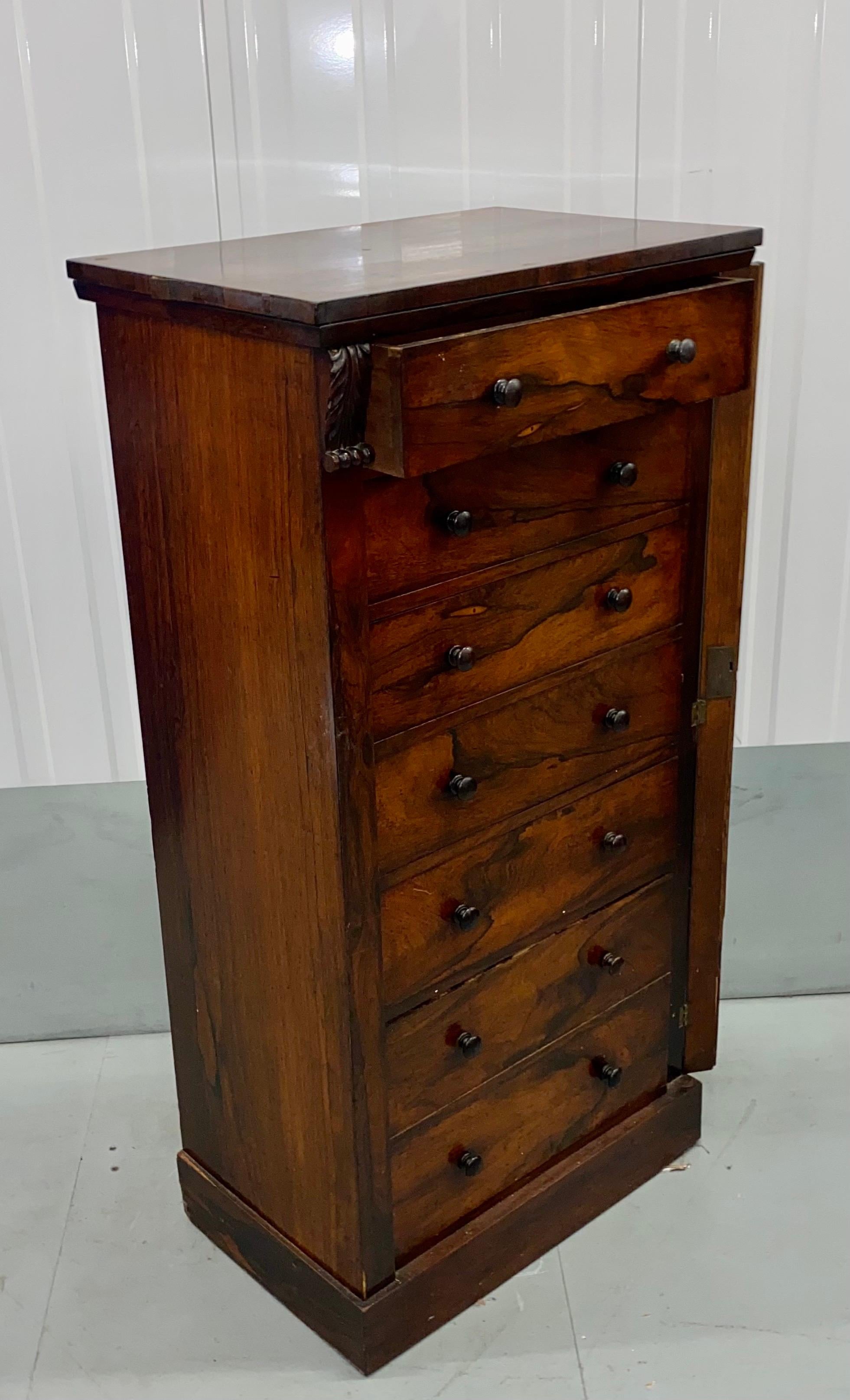 A nice antique rosewood wellington chest of drawers in good and original condition. Superb quality swirl detail o the Rosewood veneer; This is a very good example with the key that works perfectly.
Size: 54 cm x 36.5 cm x H 124 cm.