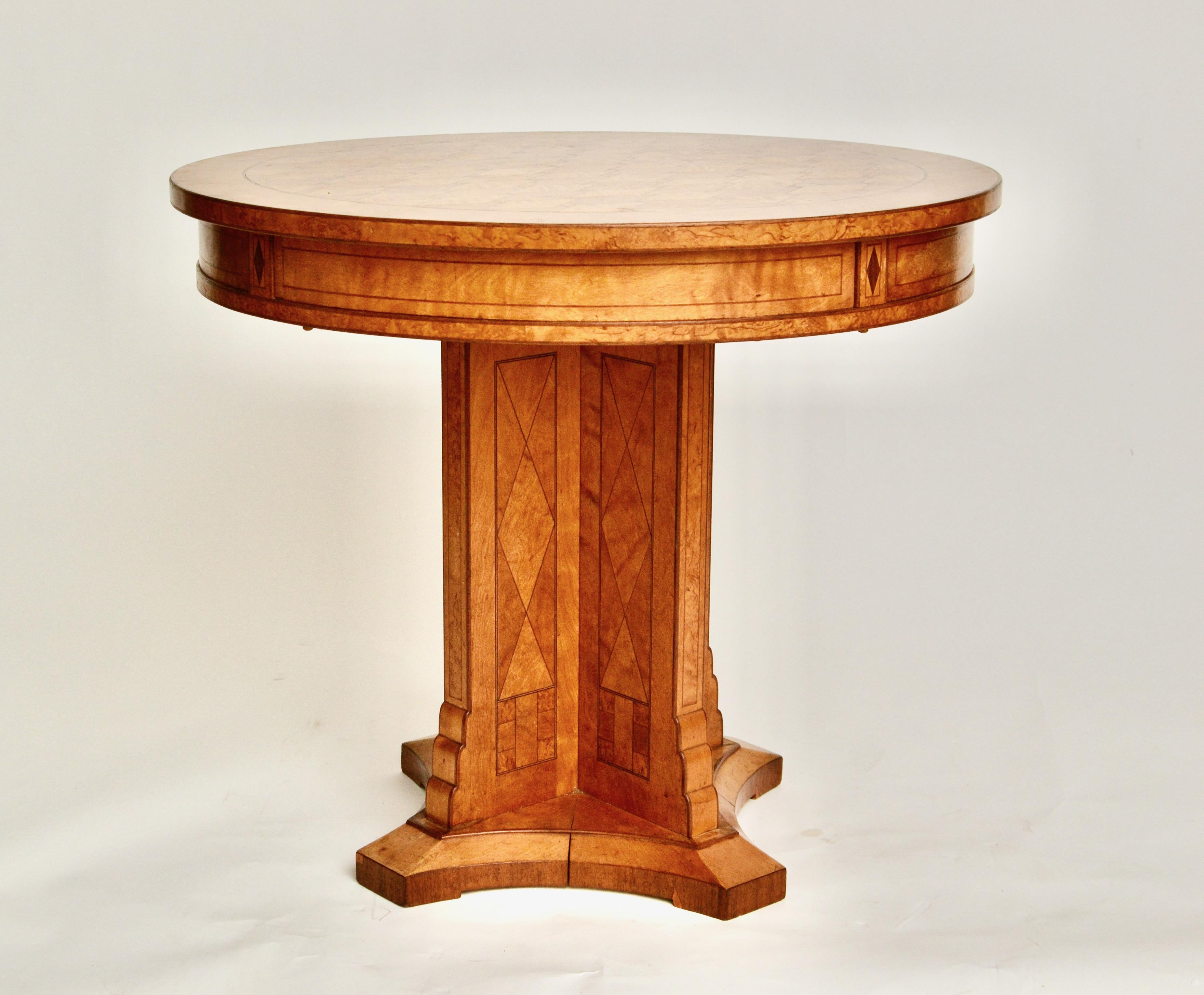 A decorative birch and birch root parquetry gueridon center table. Probably Russian, late 19th century. With four drawers with hidden push button spring release. Very nice color to the surface and the craftsmanship also very good. An unusual model. 