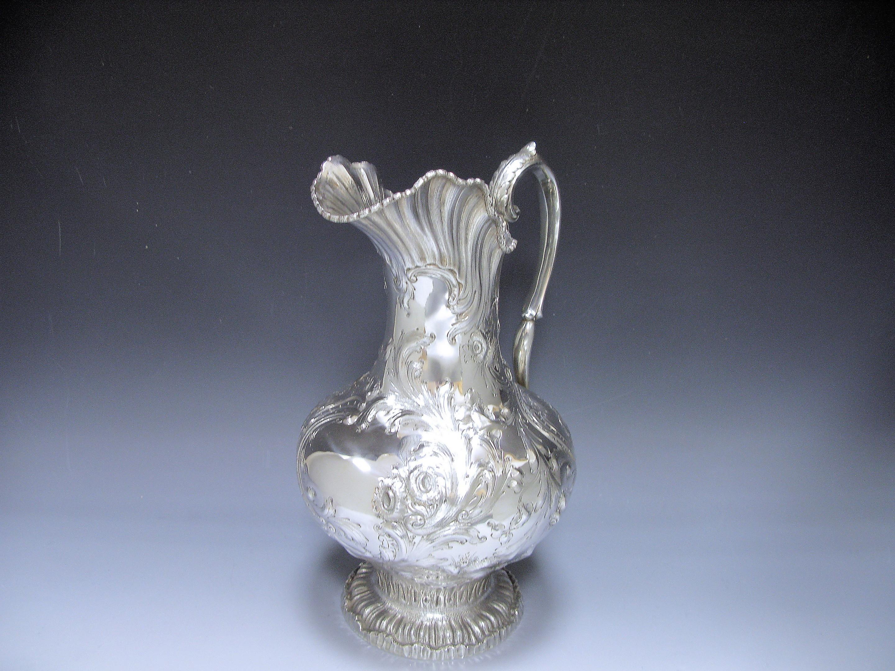 A magnificent Silver Water Jug / Ewer made by John Chandler Moore for Allcock & Allen of New York. The body of the jug is of baluster form with castellated leaf embellished rim, leaf –caped ornate scroll handles with leafy junctions, the body is