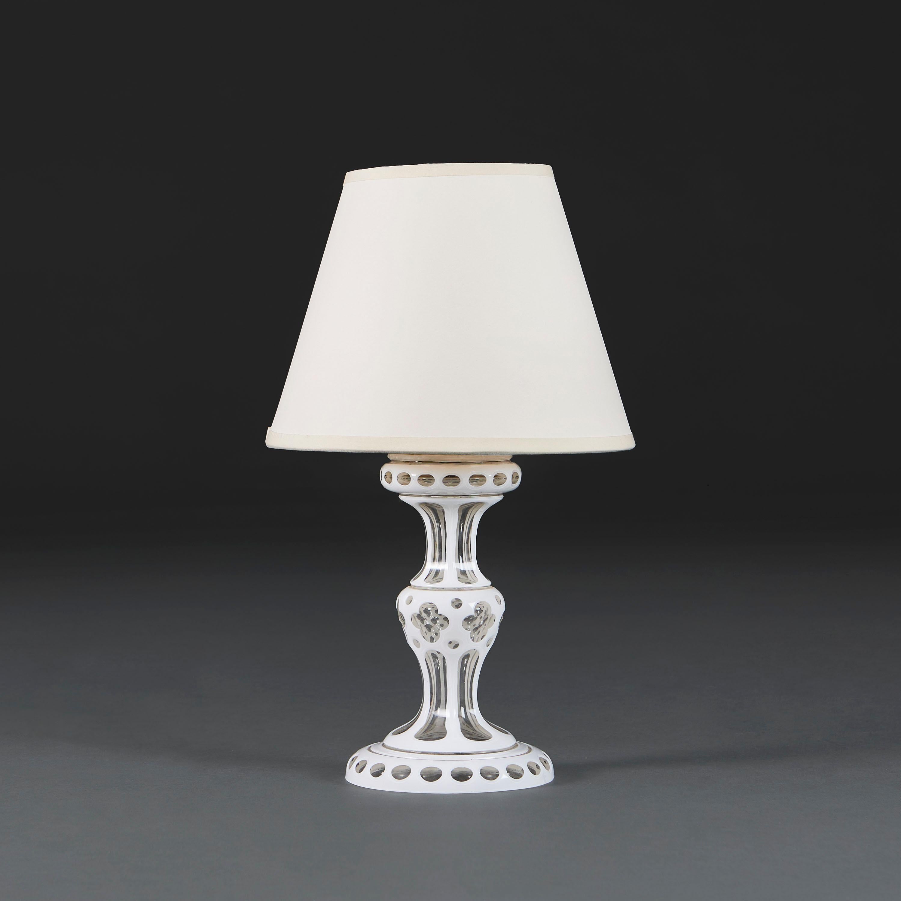 English, circa 1880

A mid 19th century white cut glass lamp of diablo form, decorated with quatrefoils to the central section.

Photographed with a 9” Pembroke lampshade in pale cream card.

Currently wired for the UK with BC bulb fitting, twisted