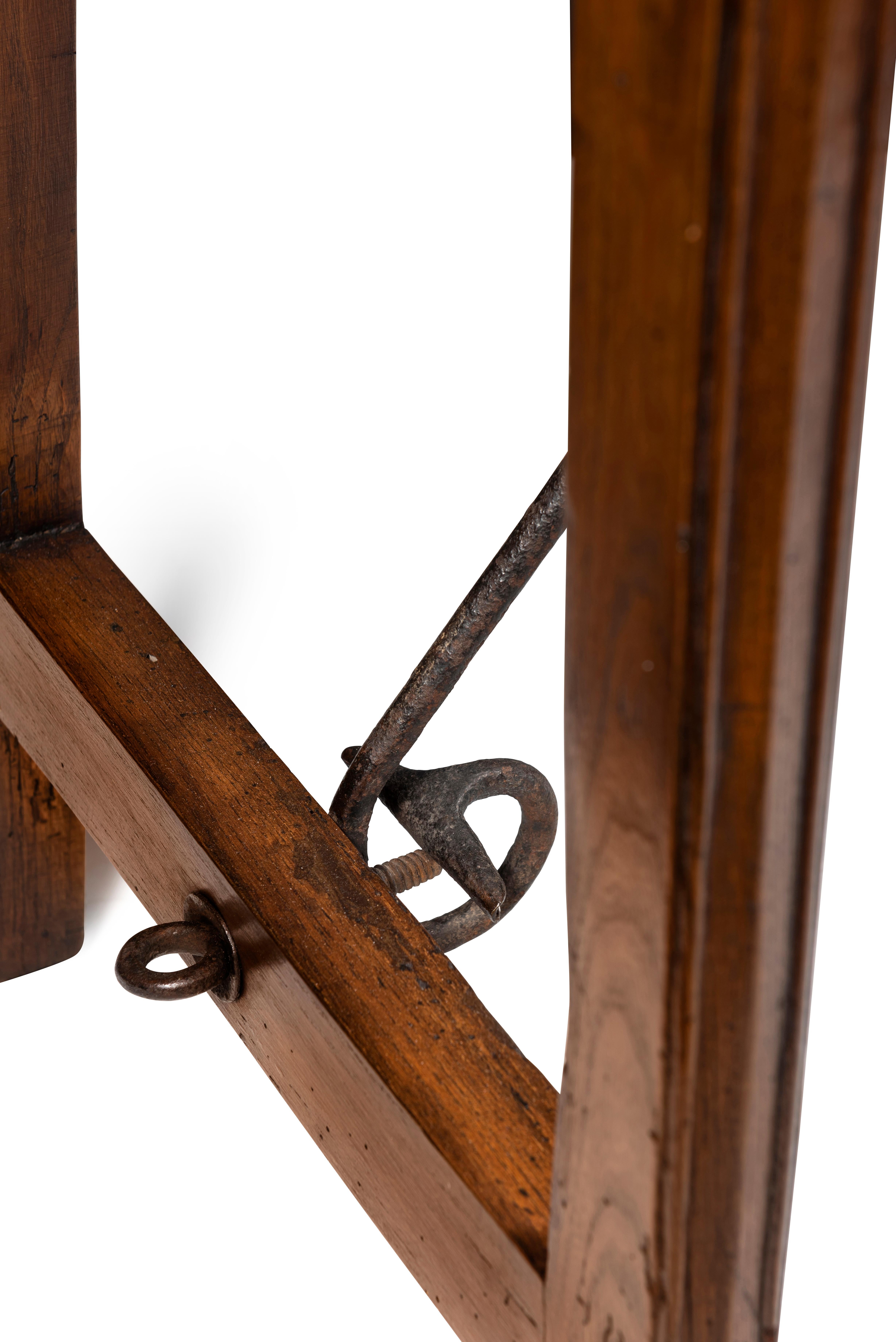 The single plank top over slender chamfered legs joined by straight iron stretcher.