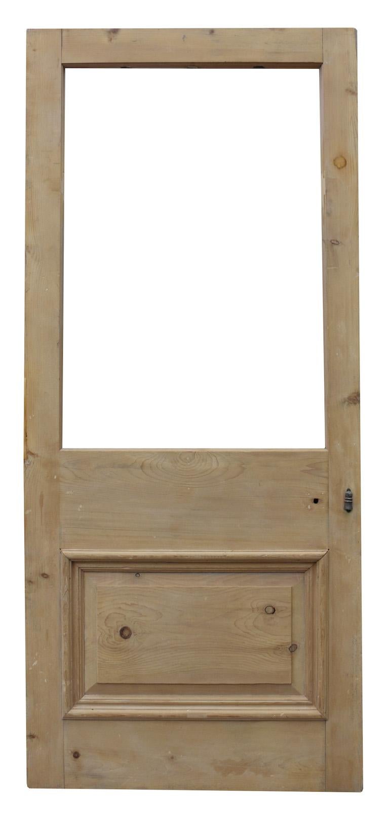 A reclaimed exterior door of two panel configuration, with space for glass.