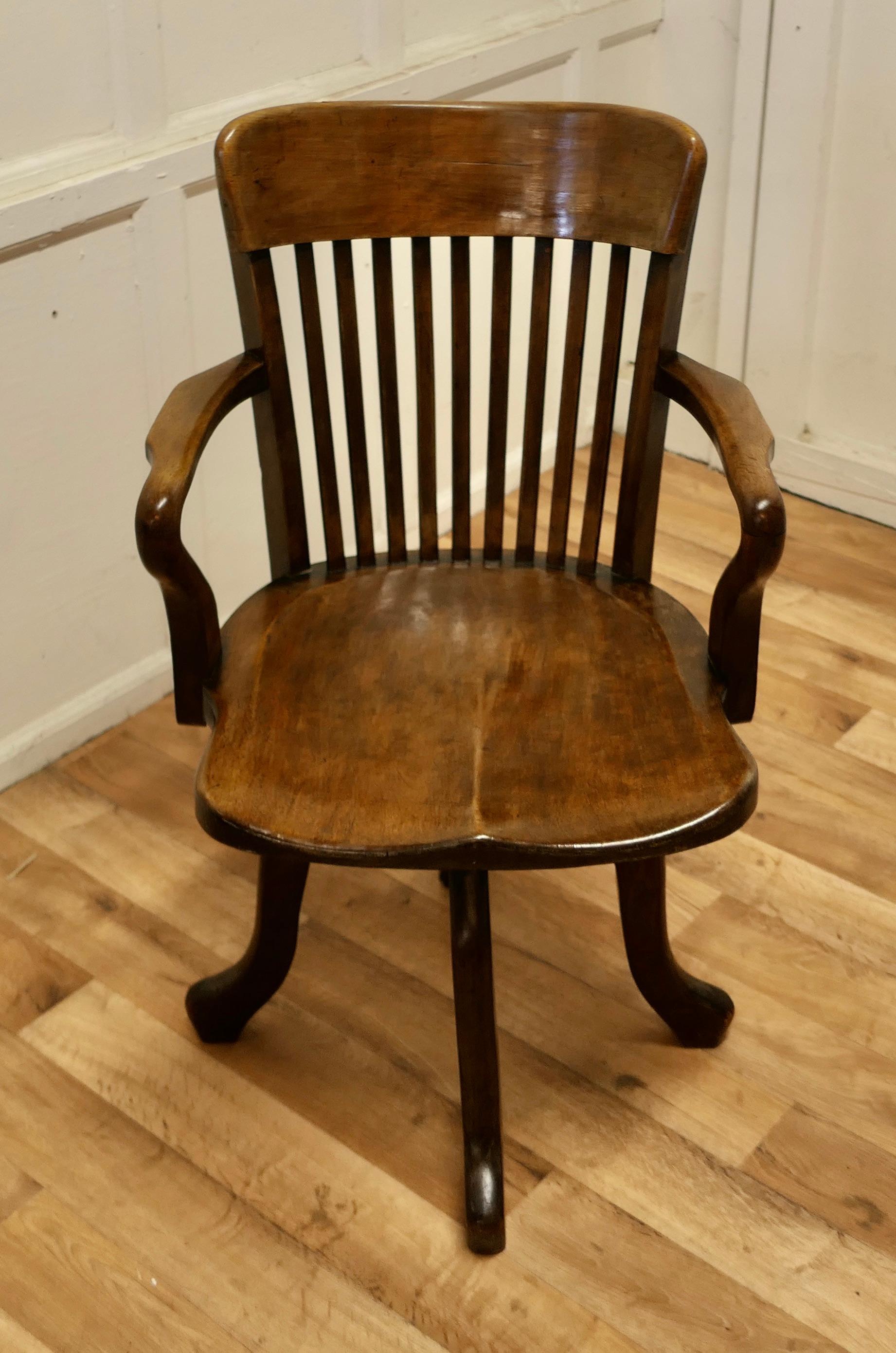 A 19th century Swivelling oak office or desk chair.

The chair was made by Frederick Mound and has an attractive deep curving back top rail with slats and arching Shepherds Crook Arm Rests, the chair has a beautifully shaped saddle seat, the chair