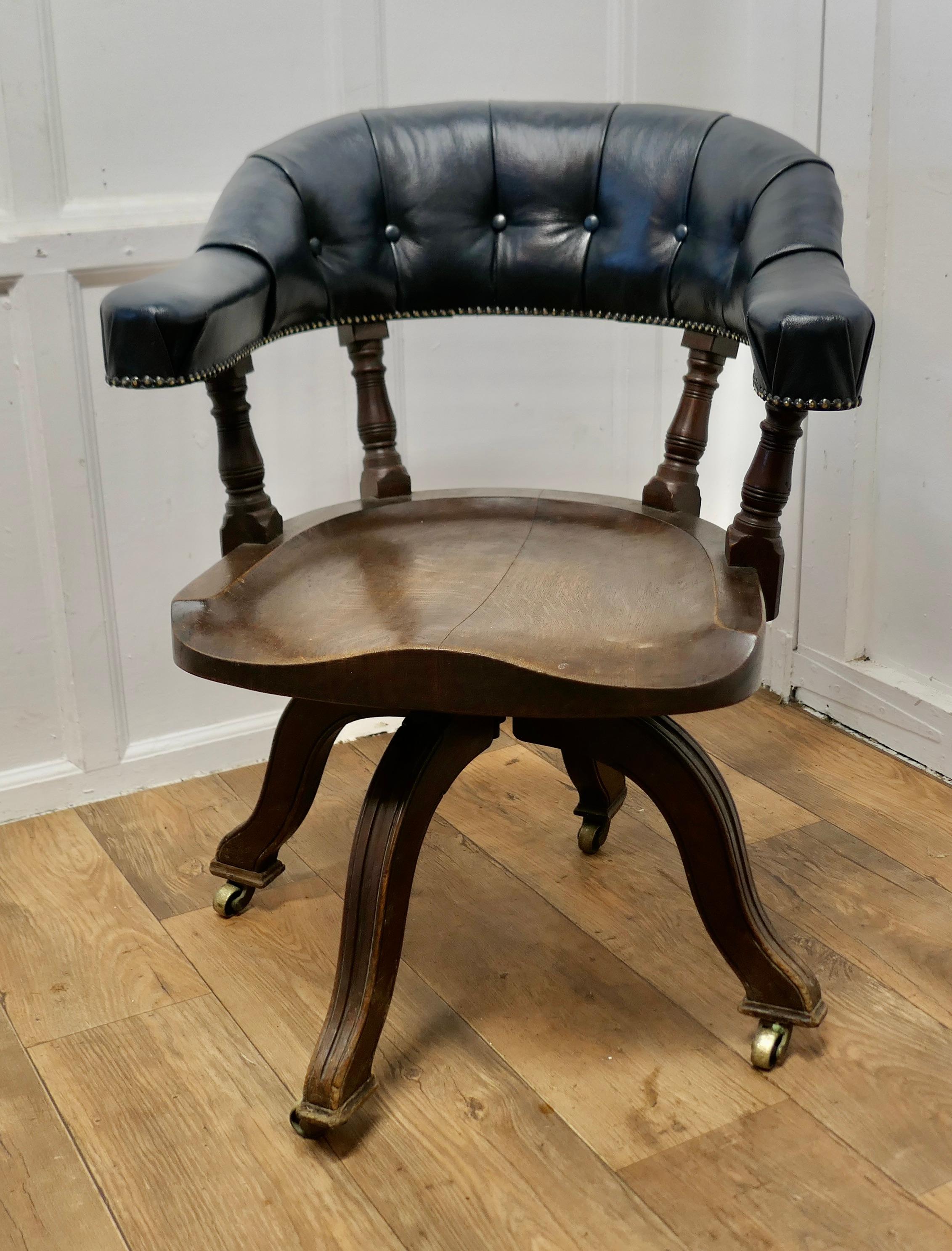 A 19th Century Swivelling Oak Office or Desk Chair 

The Chair has an attractive deep curving back top rail which is has deeply buttoned dark blue leather upholstery giving great comfort for the back and arms, the chair also has a beautifully shaped