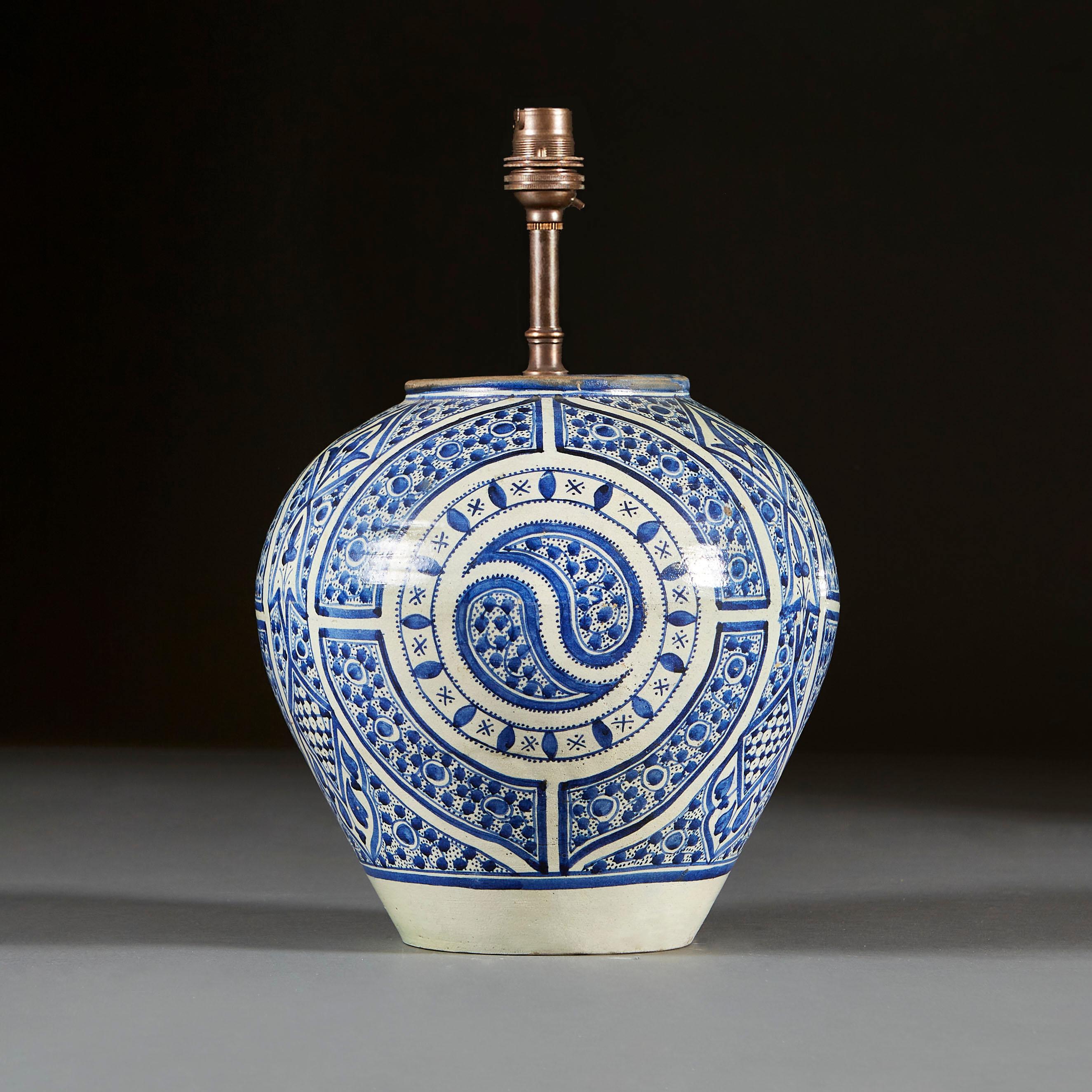 A late 19th century blue and white, bulbous vase, decorated with geometric patterns.

Currently wired for the UK with bronze colour wire with torpedo switch, with bayonet cap bulb fitting. Please enquire for rewiring services. 

Please note: