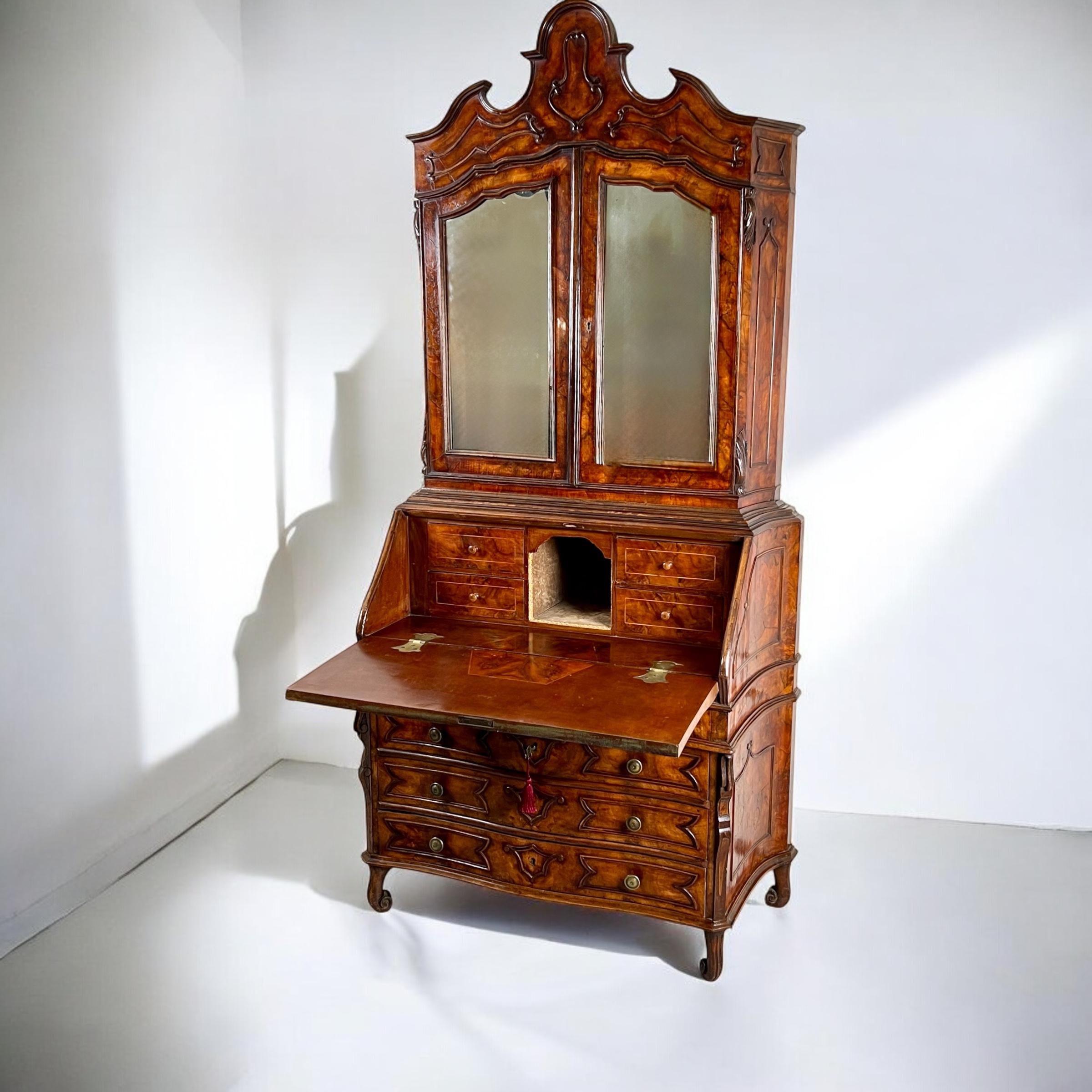 A Beautifully Crafted 19th Century Venetian Mirrored Bureau Bookcase in Briar Wood

This elegant piece features an upper section crowned with a handsome, architectural serpentine pediment. Below, the cabinet displays wonderful concave sides adorned