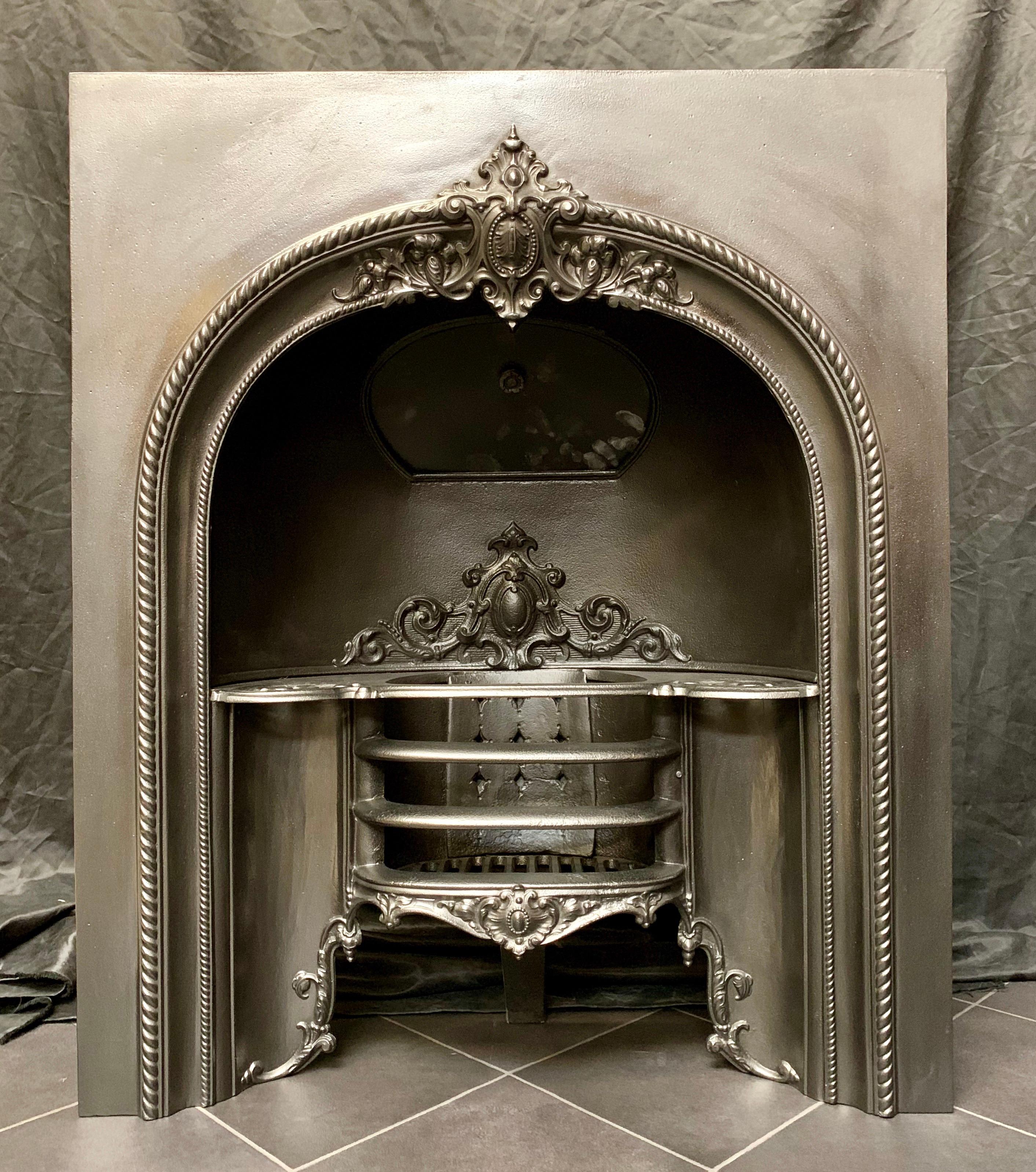 A medium sized 19th century Victorian cast iron fireplace insert, showing good quality casting, probably cast in Falkirk, Scotland, circa 1860.