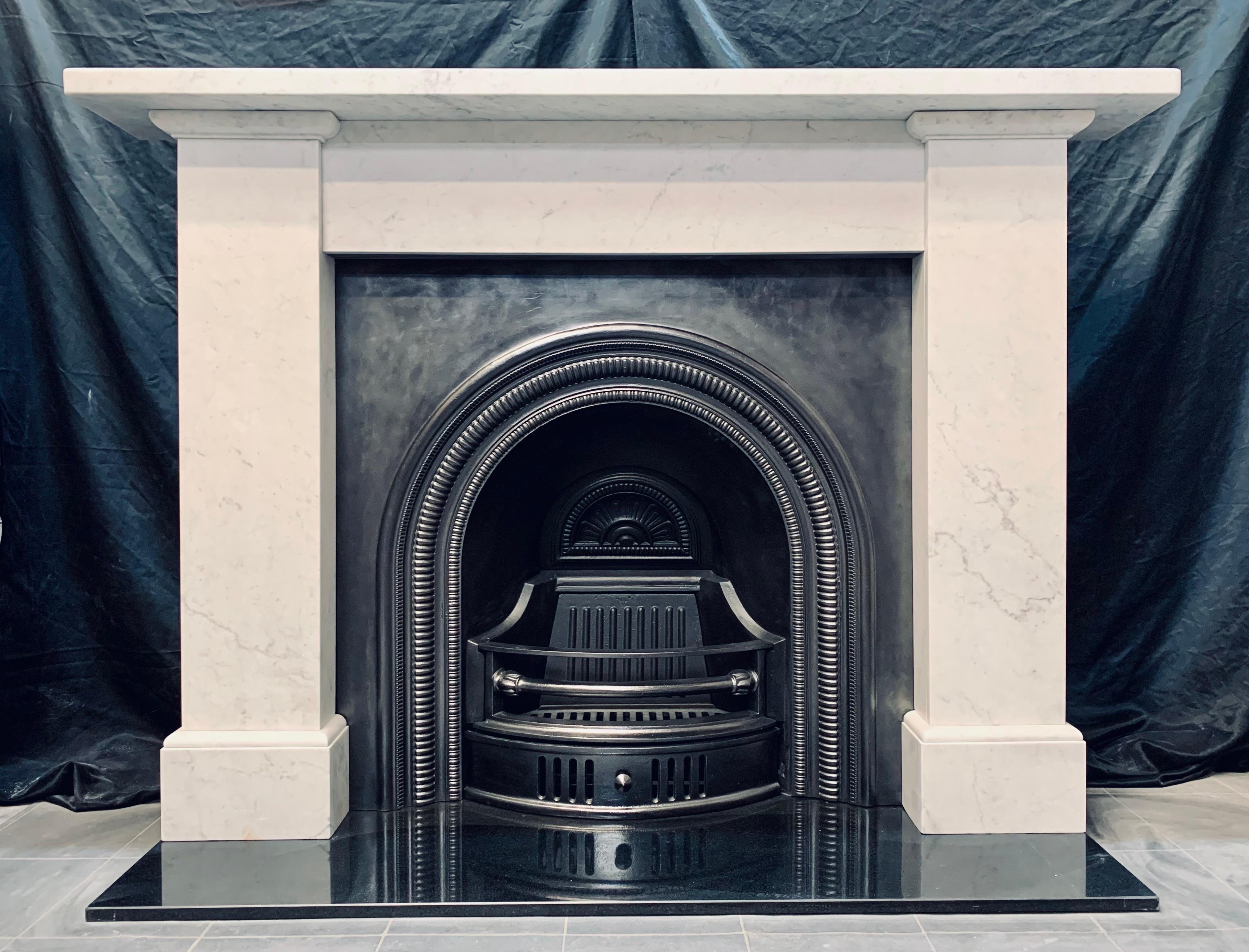 A classic 19th Century Victorian Scottish carrera marble fireplace surround. A generous square edged top shelf rests above an unadorned frieze, flanked by tall sturdy jambs with top moulded capping, ample return sections connecting the whole to the