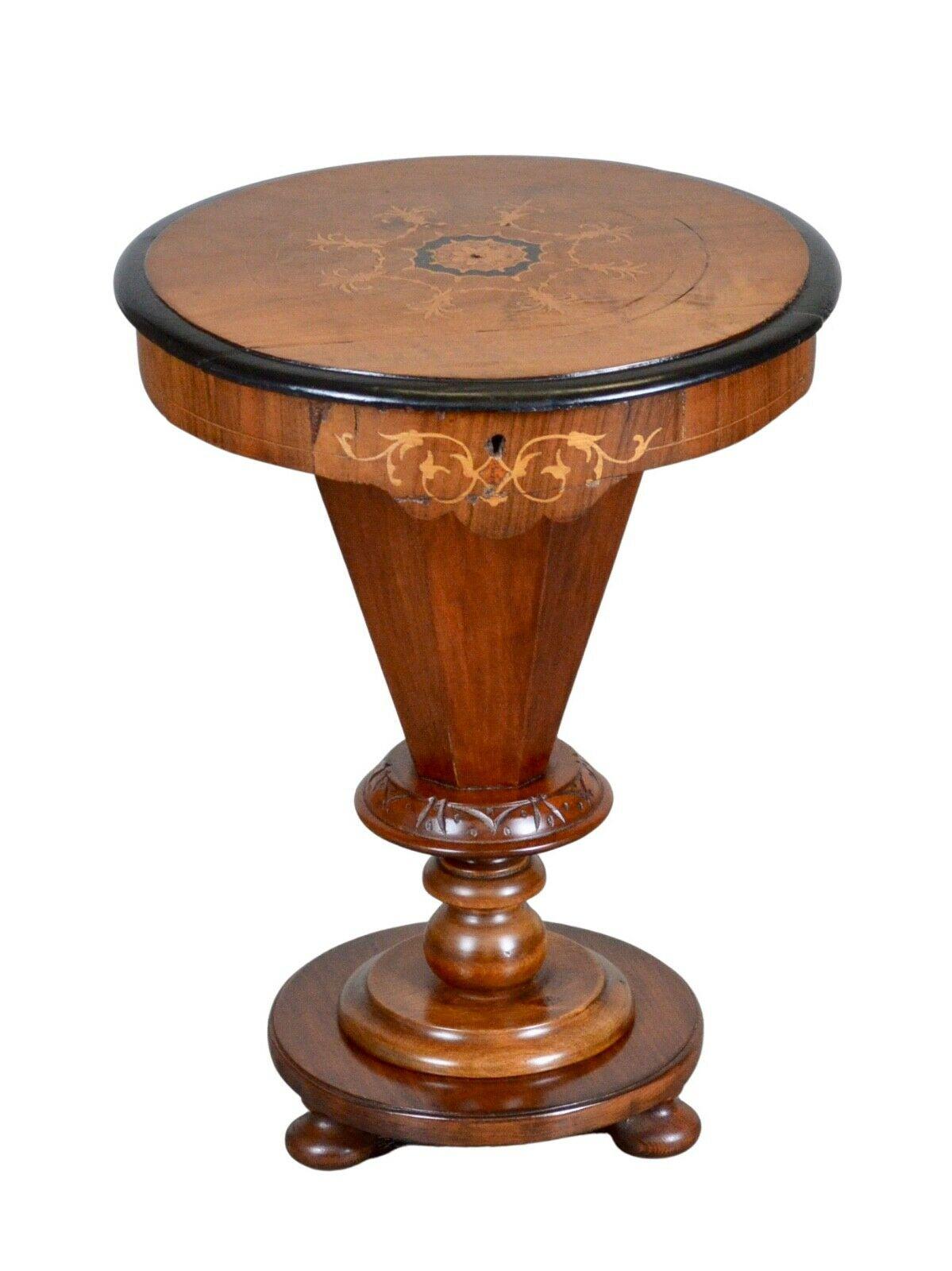 We are delighted to offer for sale this Victorian walnut trumpet circular sewing table. It is ideal for the craft-type person and can be used as a side lamp table.

The table has an inlaid top with ebonised banding to the edge, a trumped base, and