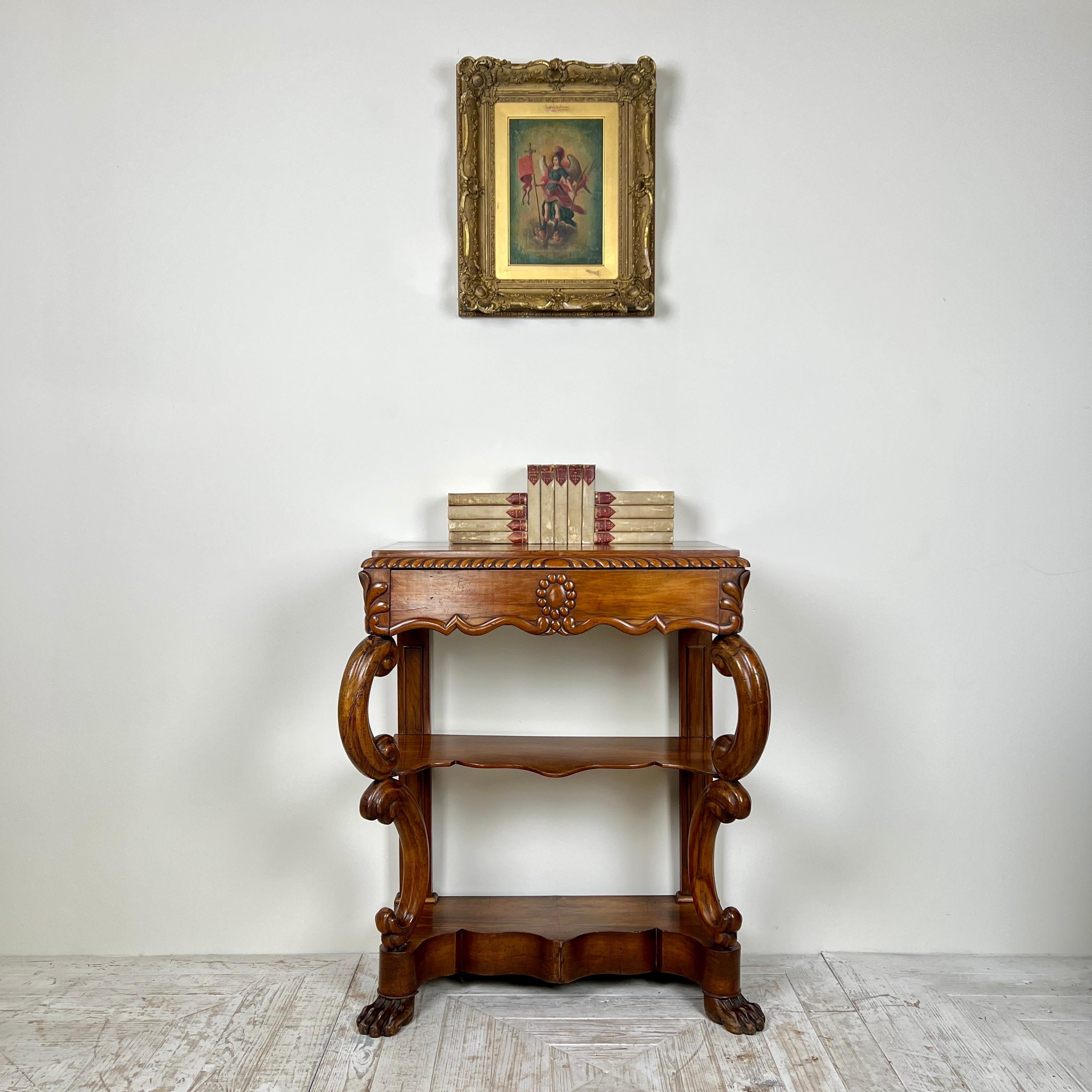 A lovely 19th-century walnut console table.

The rectangular top features an attractive gadrooned edge and floral detailing at the corners, with a generously sized drawer for storage.
It is supported by beaded stiles at the rear and elegant C-scroll