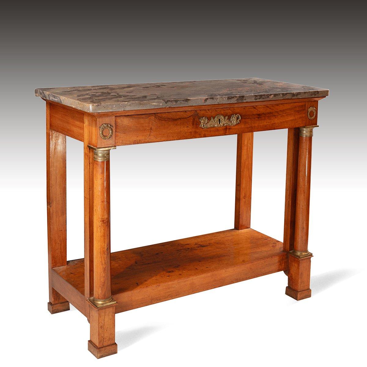The table retaining the original thick marble top above a walnut base that has a frieze drawer. With flanking columns and a platform base, the table is further enhanced with original decorative ormolu mounts. It is a lovely warm walnut colour and it