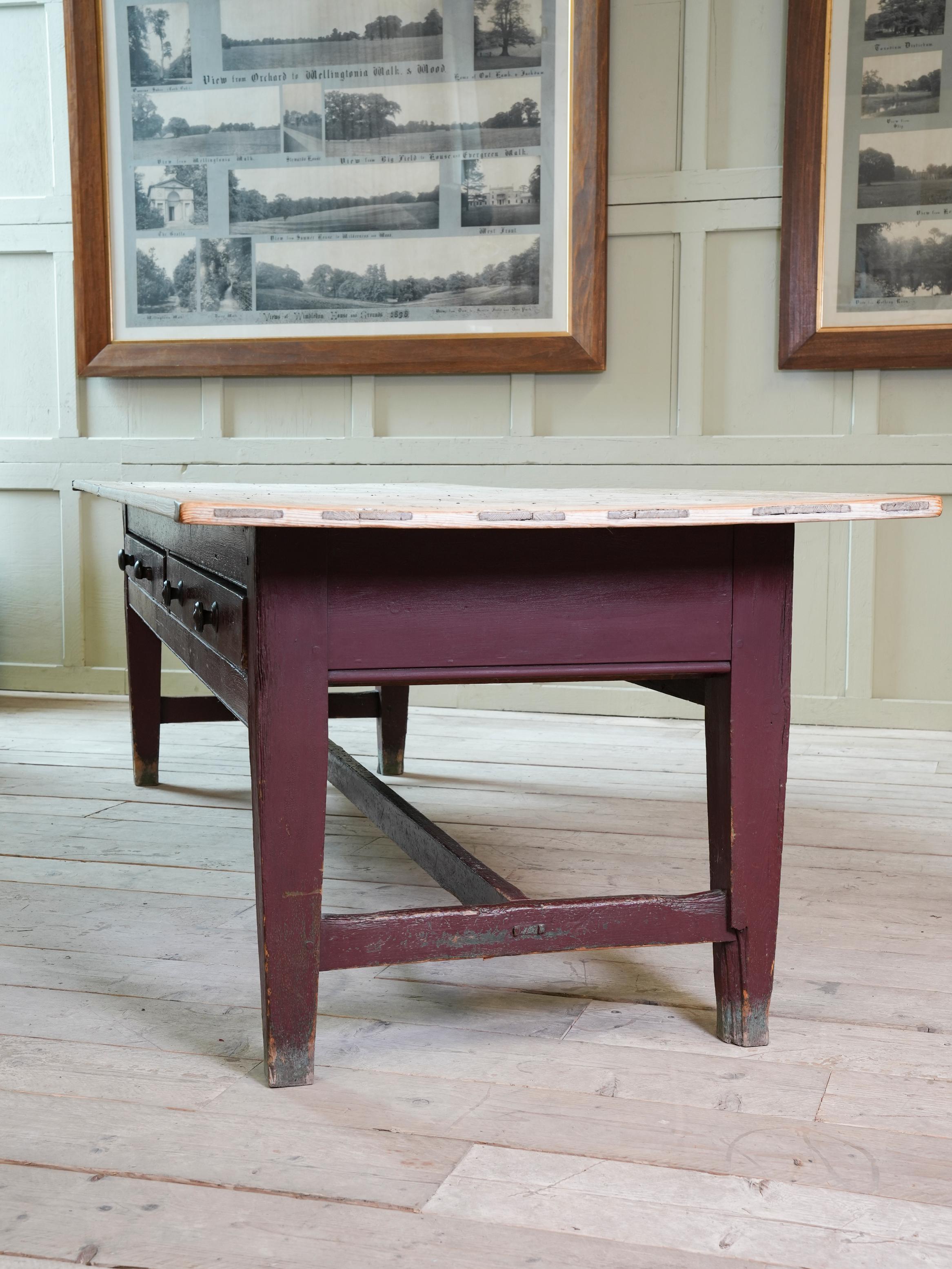 We acquired this magnificent table directly from the two thousand acre, 18th Century Manor House “Plas Gwyn” near Pentraeth on Anglesey, North Wales.

The plum paint to the pine frame and double sided drawers are wholly original and have acquired