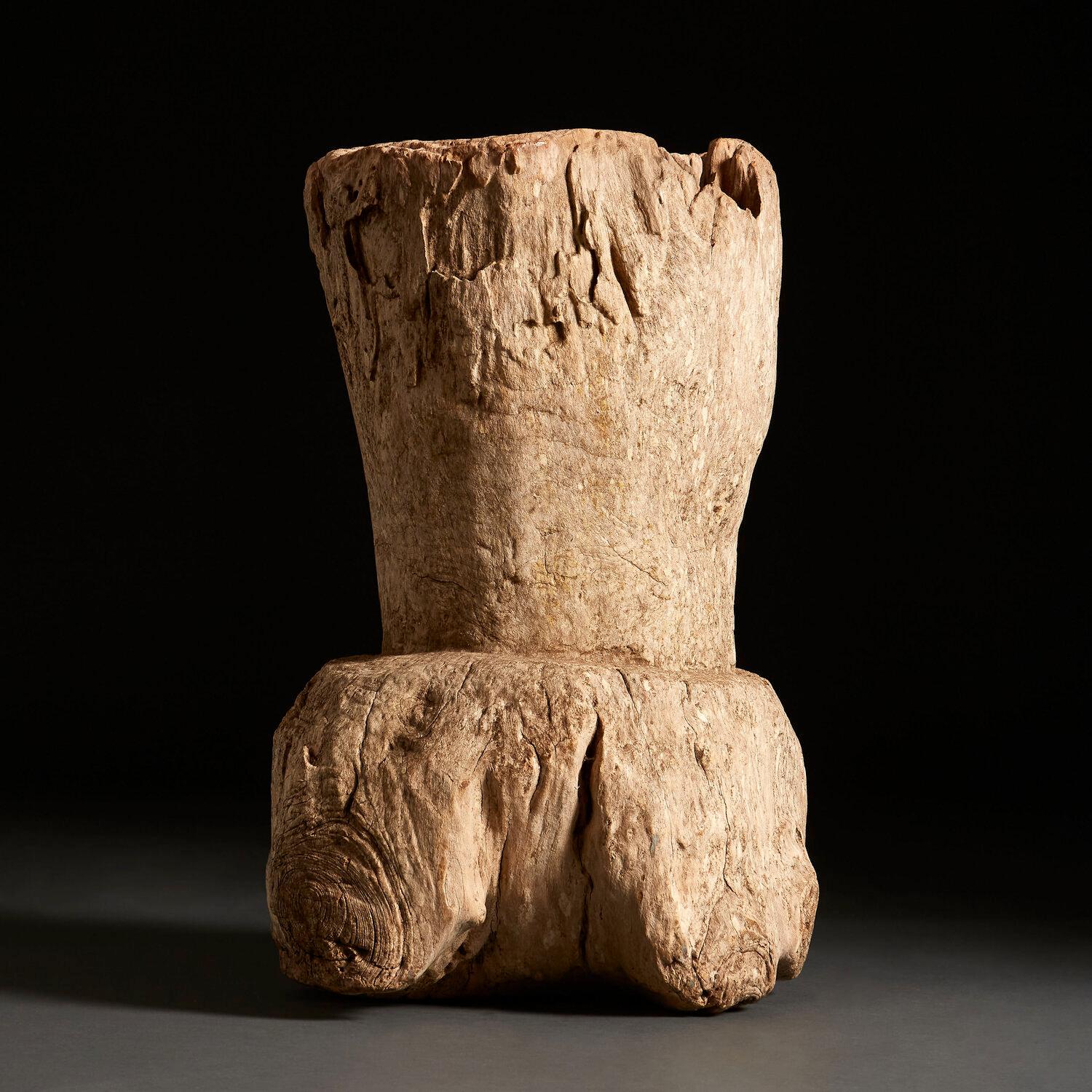A large root wood form with hollowed centre, with knots to the surface throughout. Possibly a mortar, or for use as a stick stand.