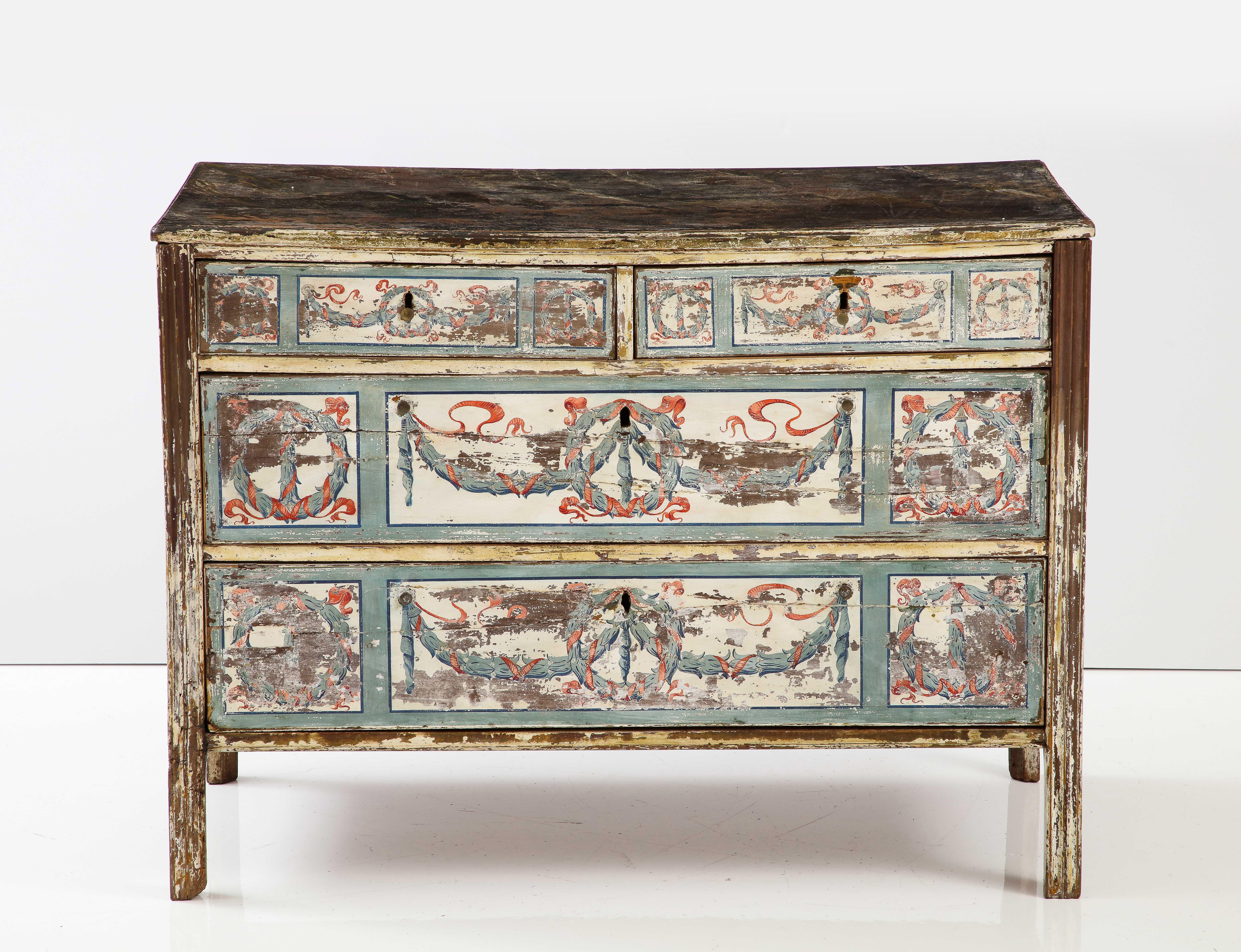 We love this piece for its wonderful, soft patina. This unique chest is decorated in a Neoclassical motif, painted throughout in soft cream, blue and red.  The painted top sits above two small drawers and three large drawers.  Its clean lines give