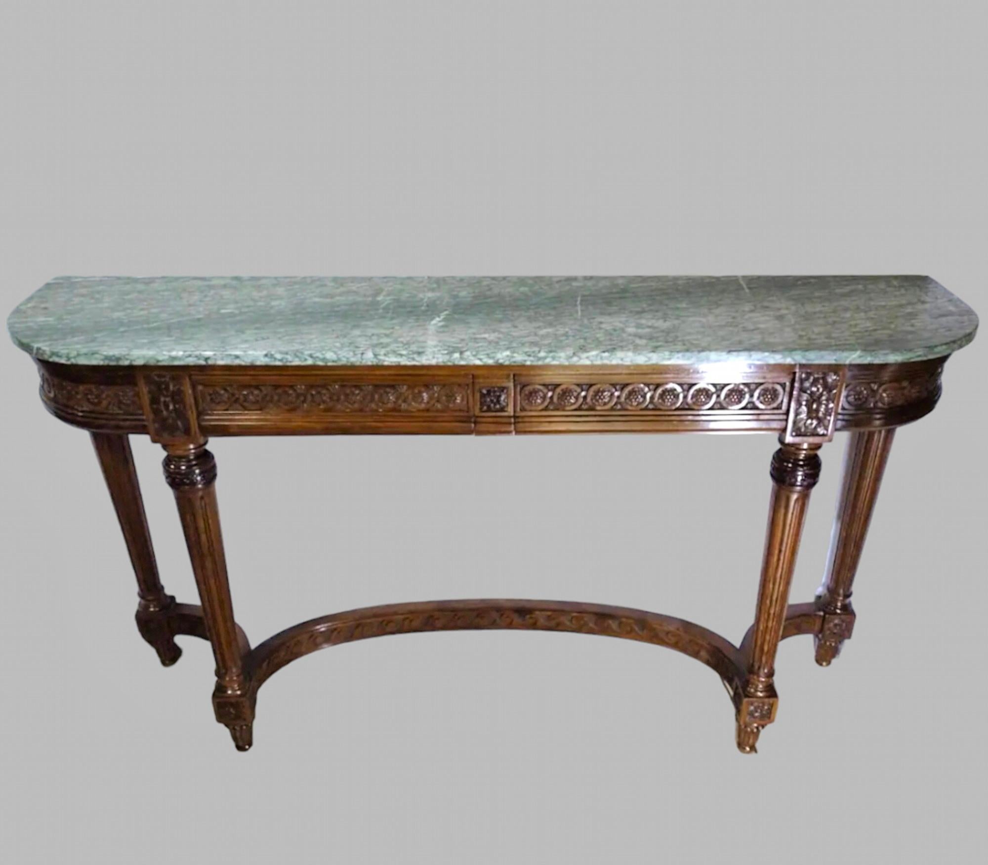 A Lovely 19th century Carved Walnut Console Table on carved and molded legs joined by a carved curved stretcher. It has two hidden drawers and an original green marble top that has two very minor chips to edges commensurate with age and patina.